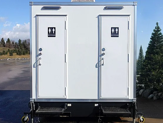 portable restroom trailer for construction job sites with two private stalls and exterior entry steps