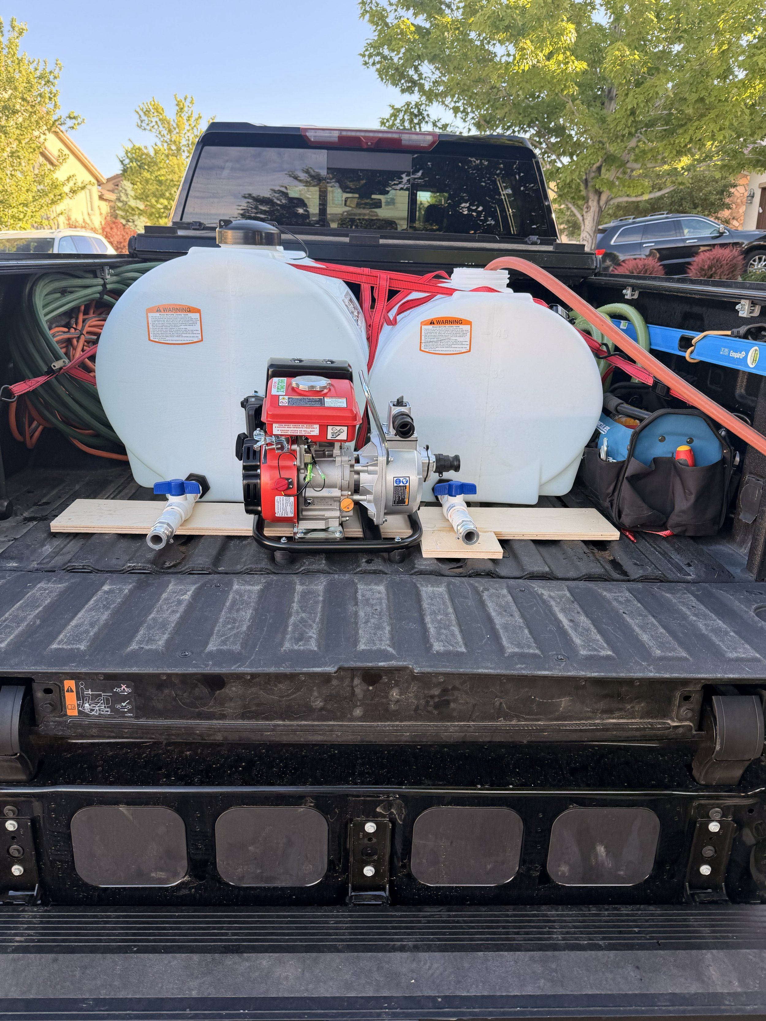 Fresh water transfer tanks and pump system used to supply running water to luxury restroom trailers at remote Colorado event locations.