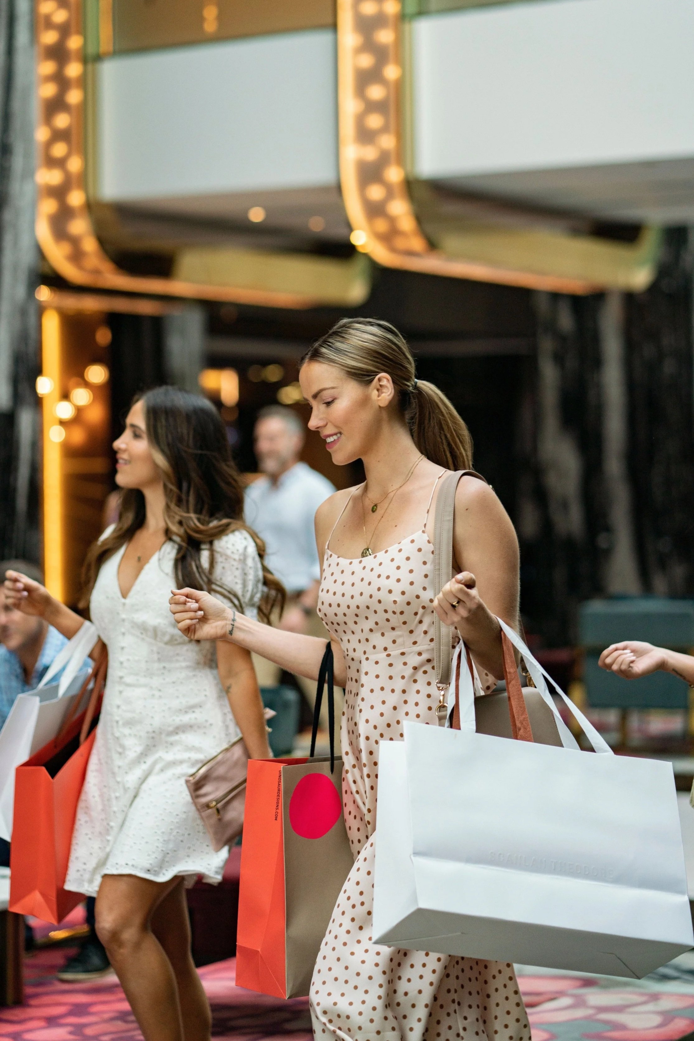 Women holding shopping bags and laughing