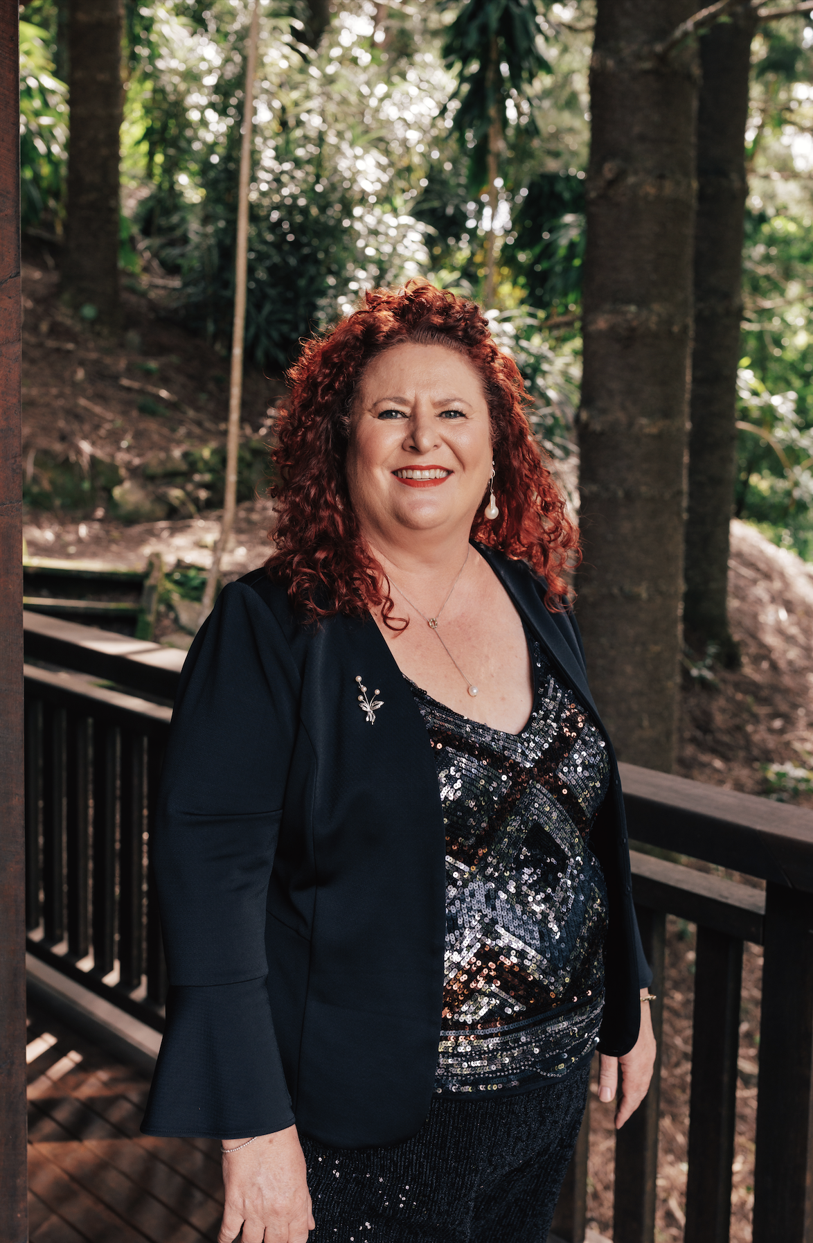 Kate Ellis, Brisbane celebrant, smiling warmly in a garden — approachable, professional and genuine