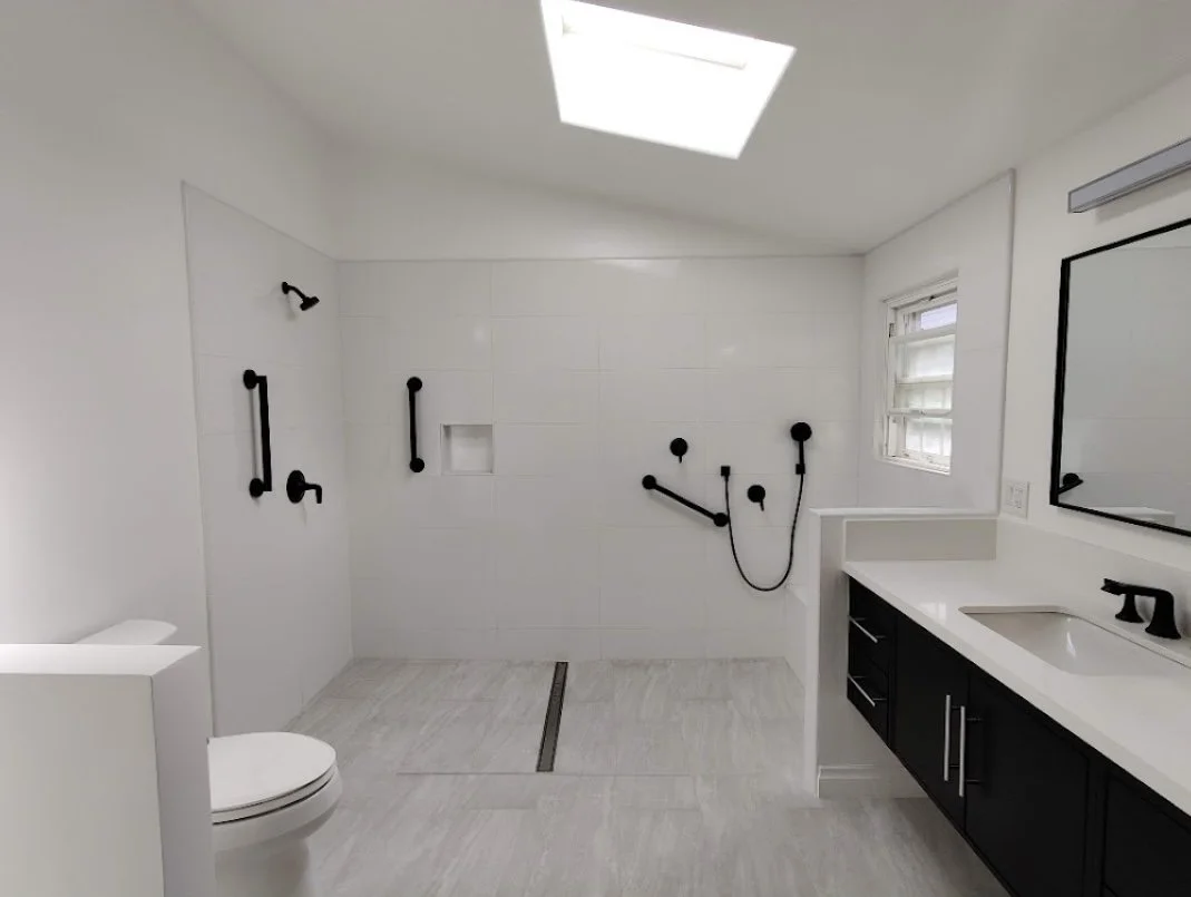 White and black modern full bathroom renovation. Open shower and tile work.
