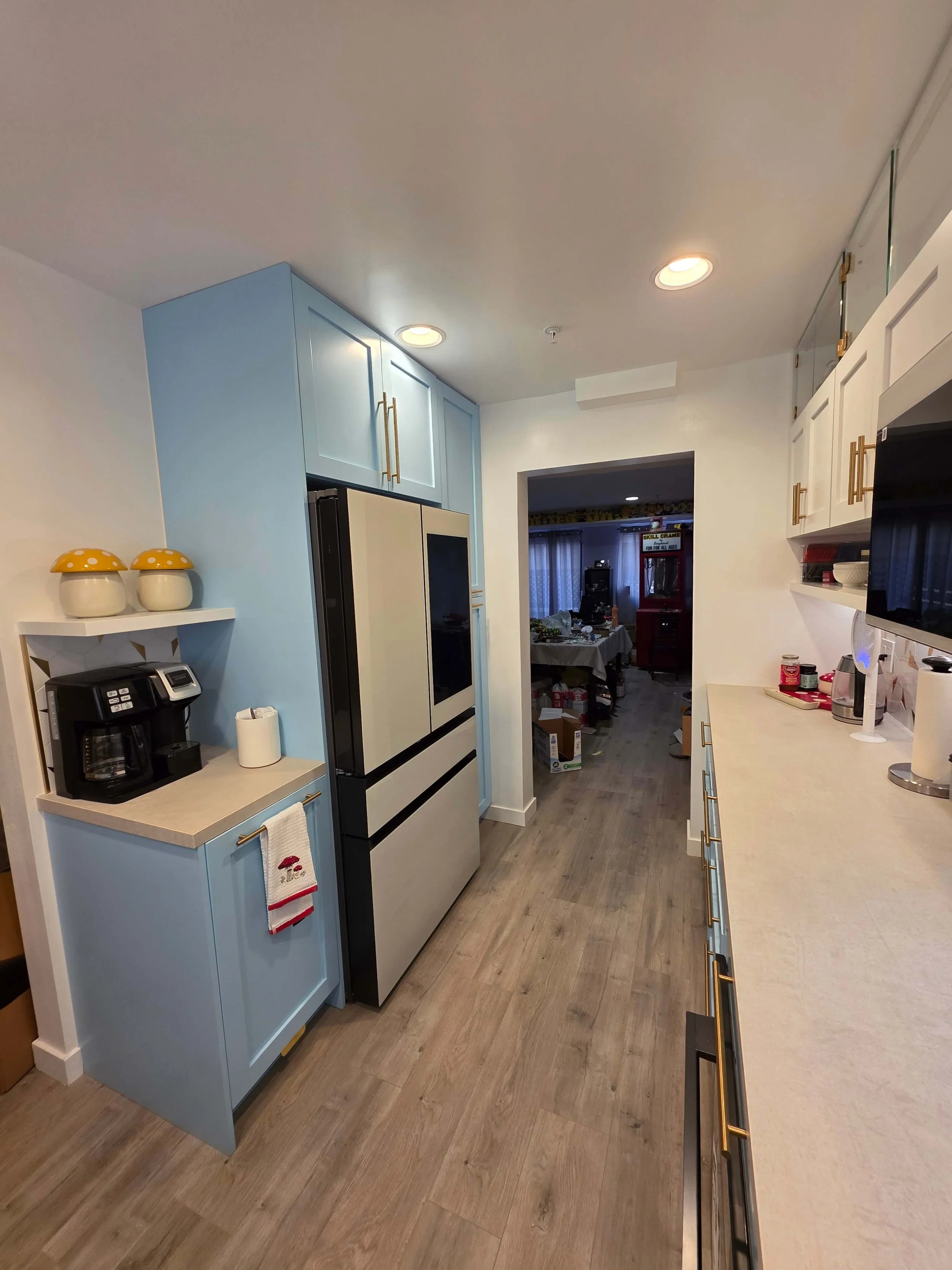 Complete remodel custom kitchen. Blue cabinets. White counters. Modern appliances.