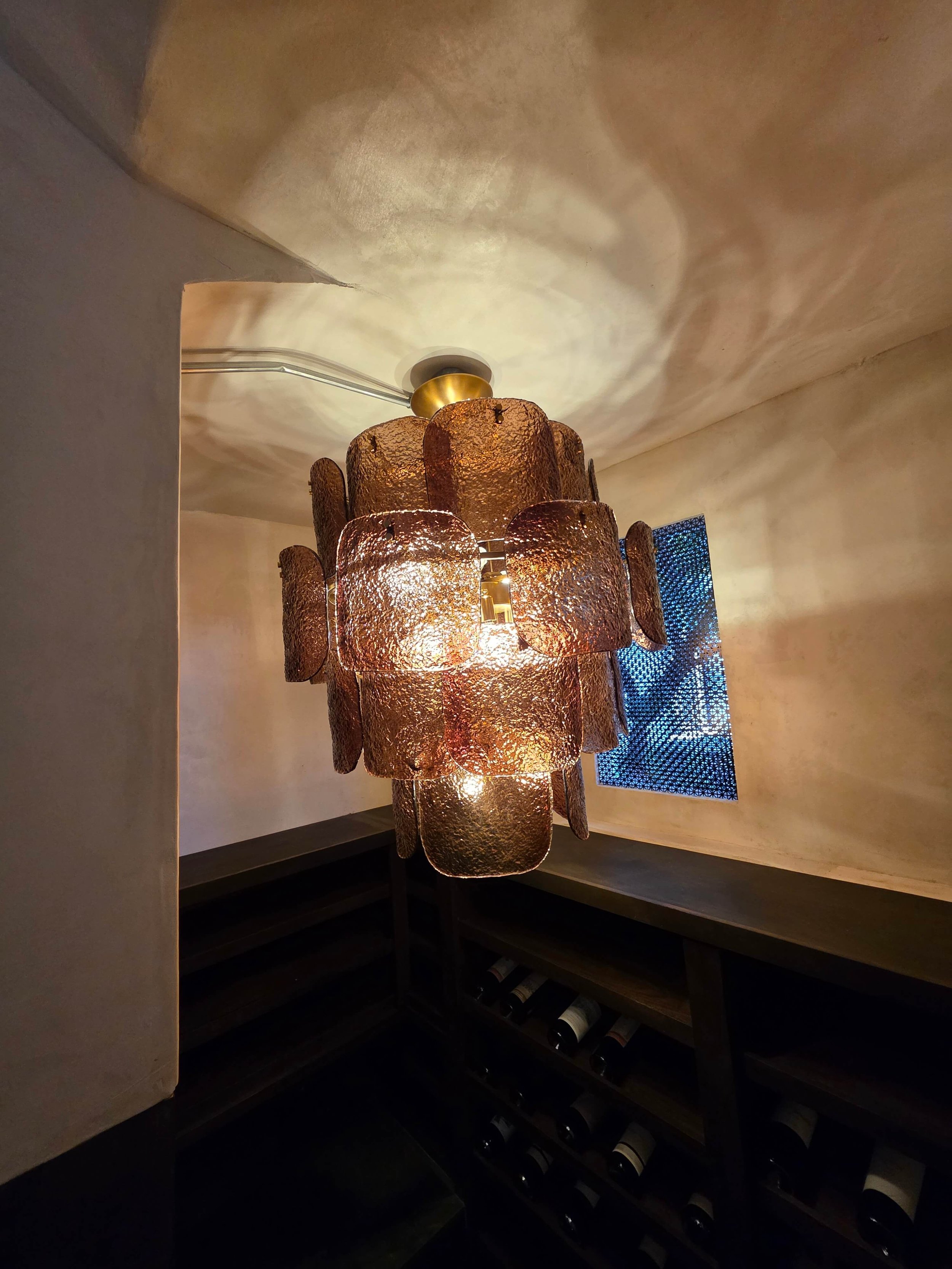 Custom wine cellar with gold Chandelier.