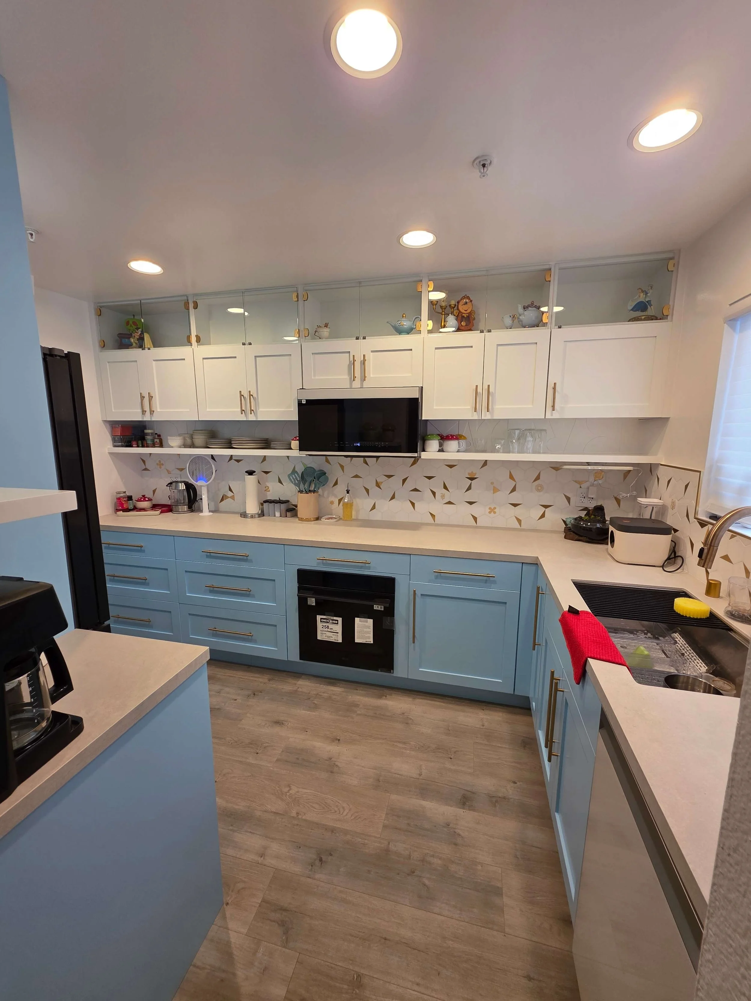 Complete remodel custom kitchen. Blue cabinets. White counters. Steel Sink. 