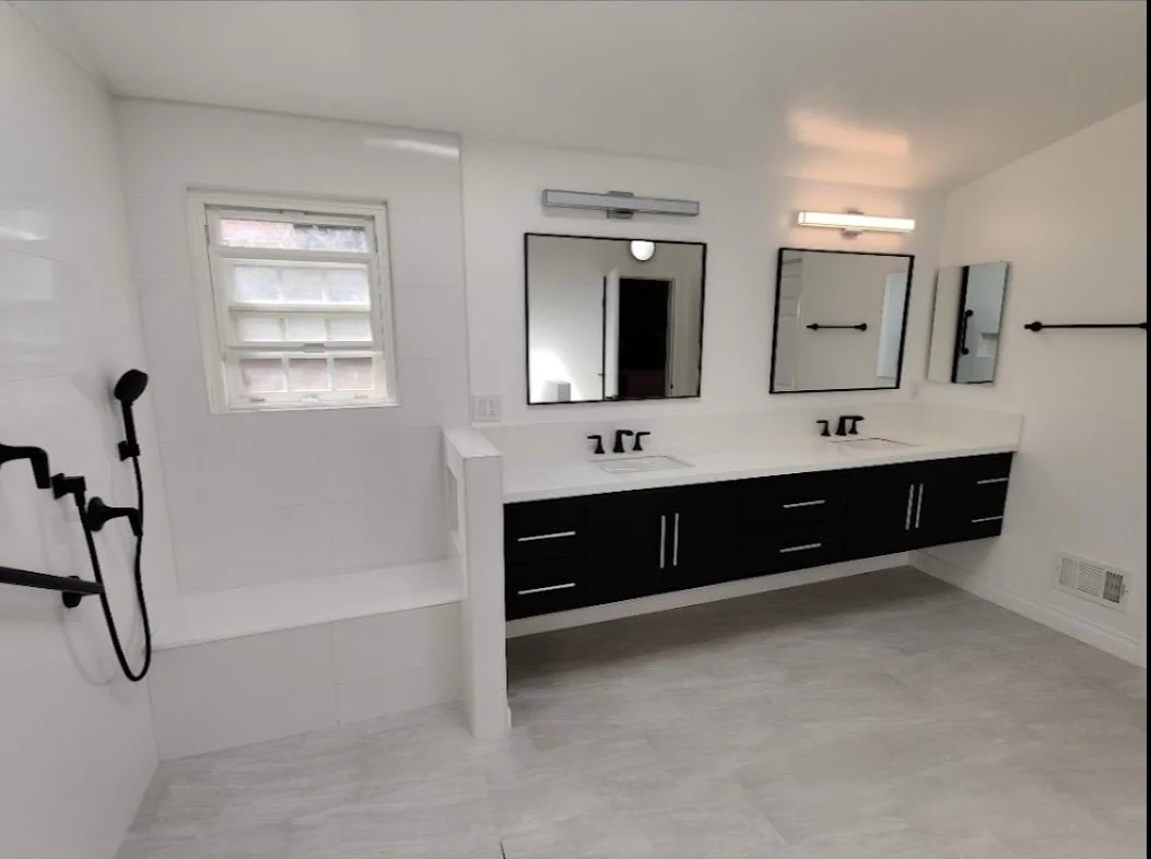 White and black modern full bathroom renovation. All black cabinets. 
