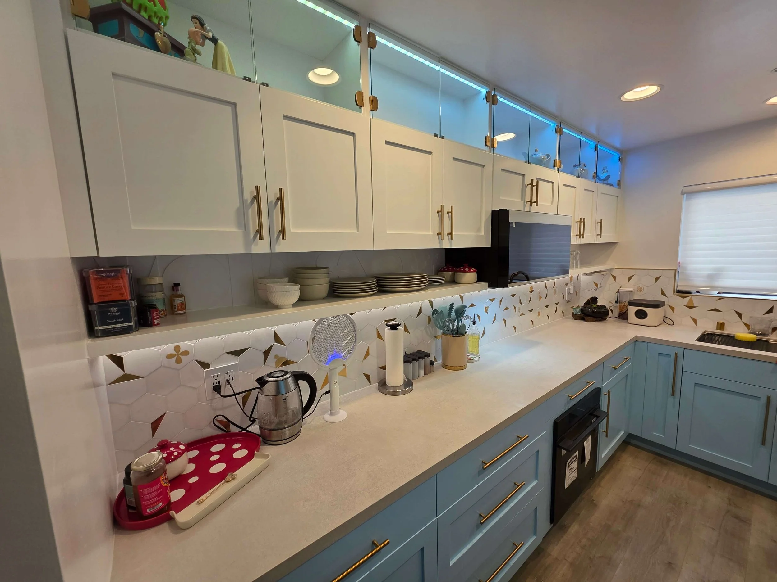 Complete remodel custom kitchen. Blue cabinets. White counters. Tile work. Custom finsihes.