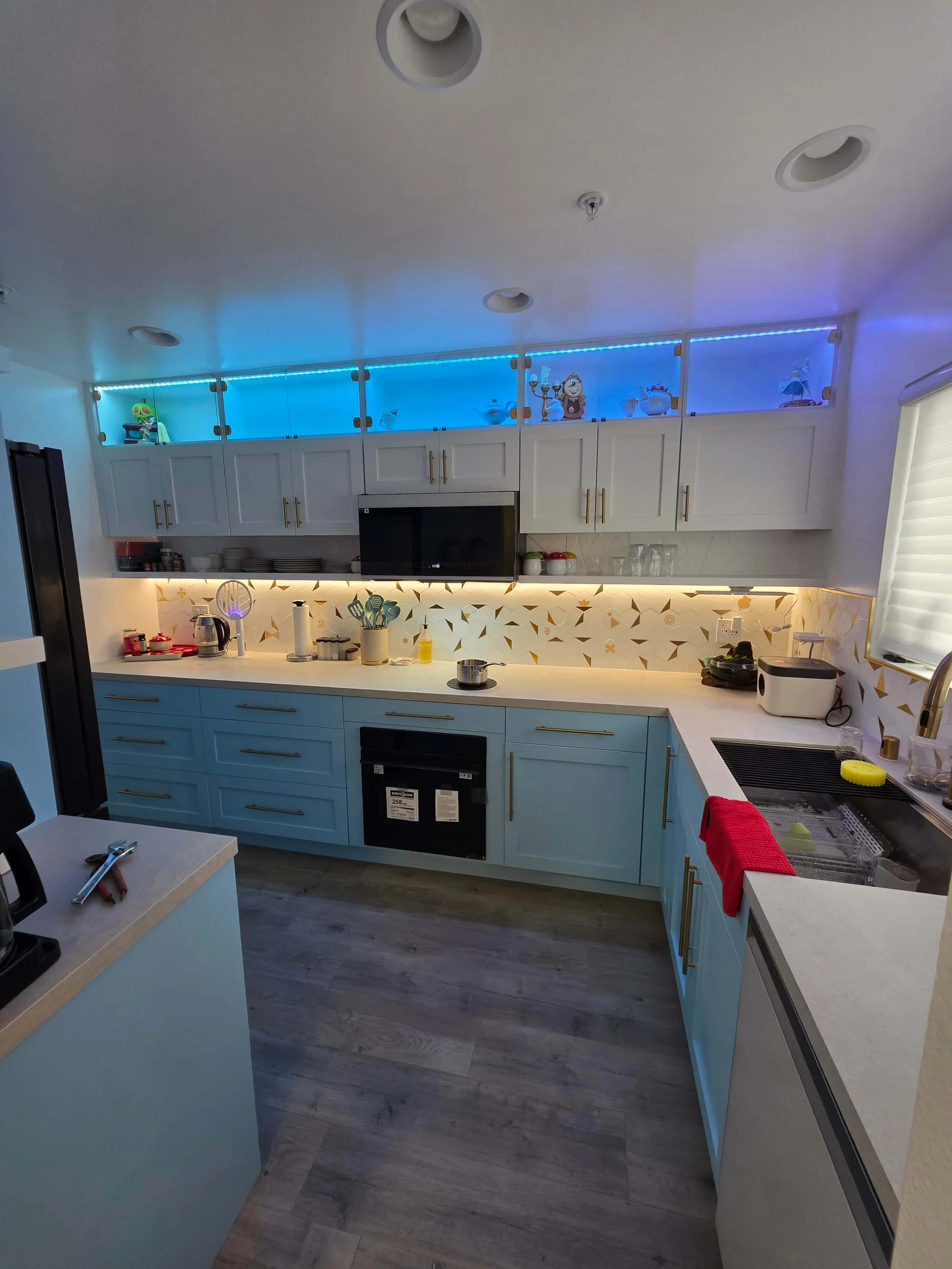 Complete remodel custom kitchen. Blue cabinets. White counters. Steel Sink. Custom lighting.