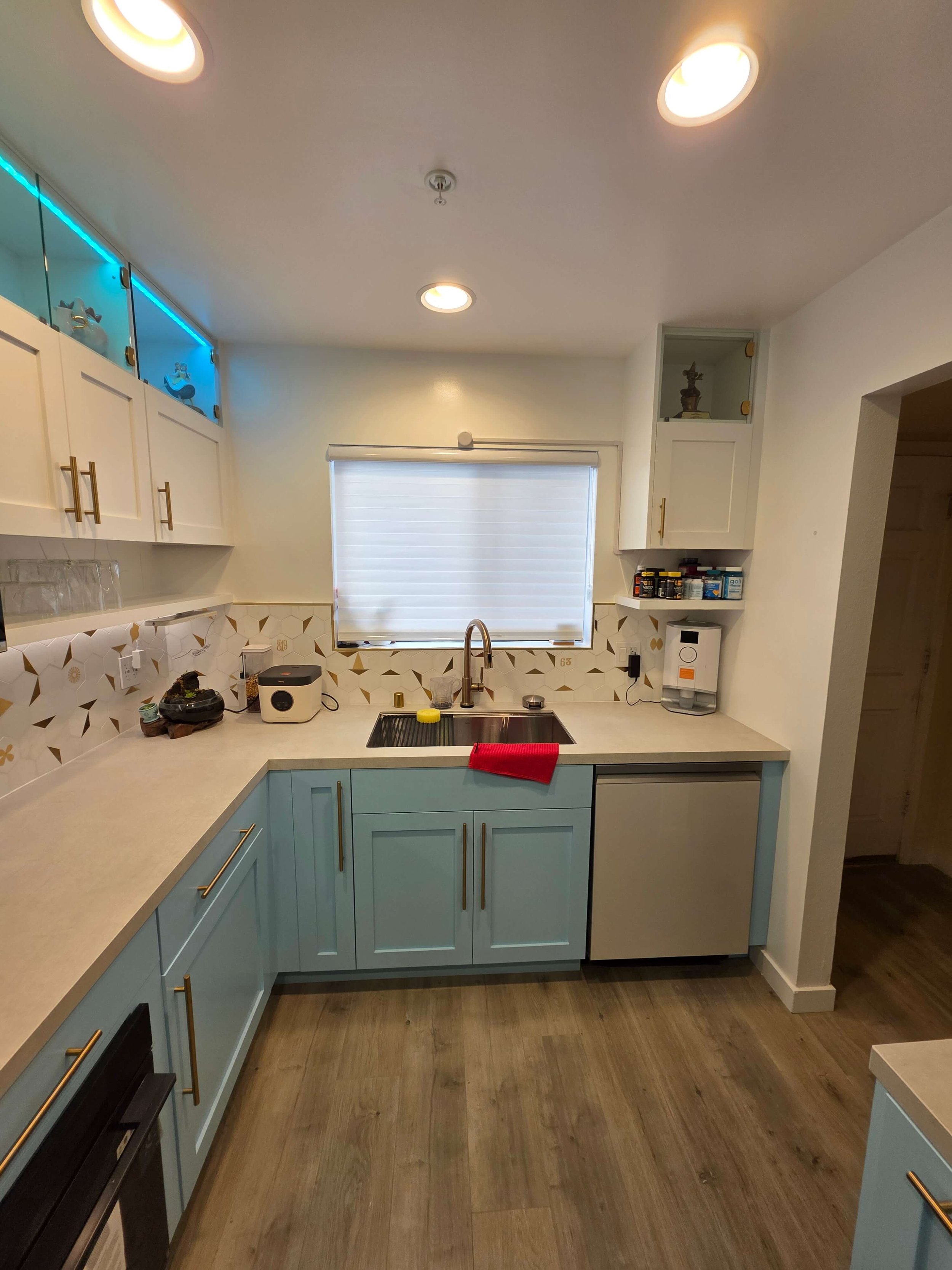 Complete remodel custom kitchen. Blue cabinets. White counters. Steel Sink. 