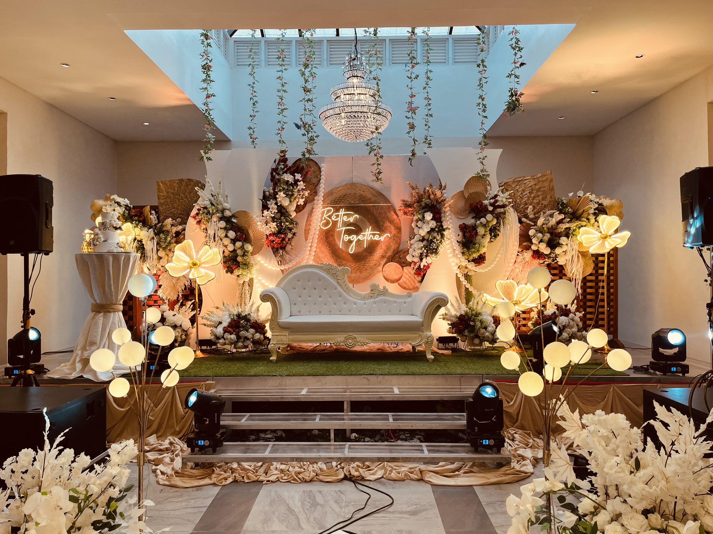 A decorated stage with floral arrangements.