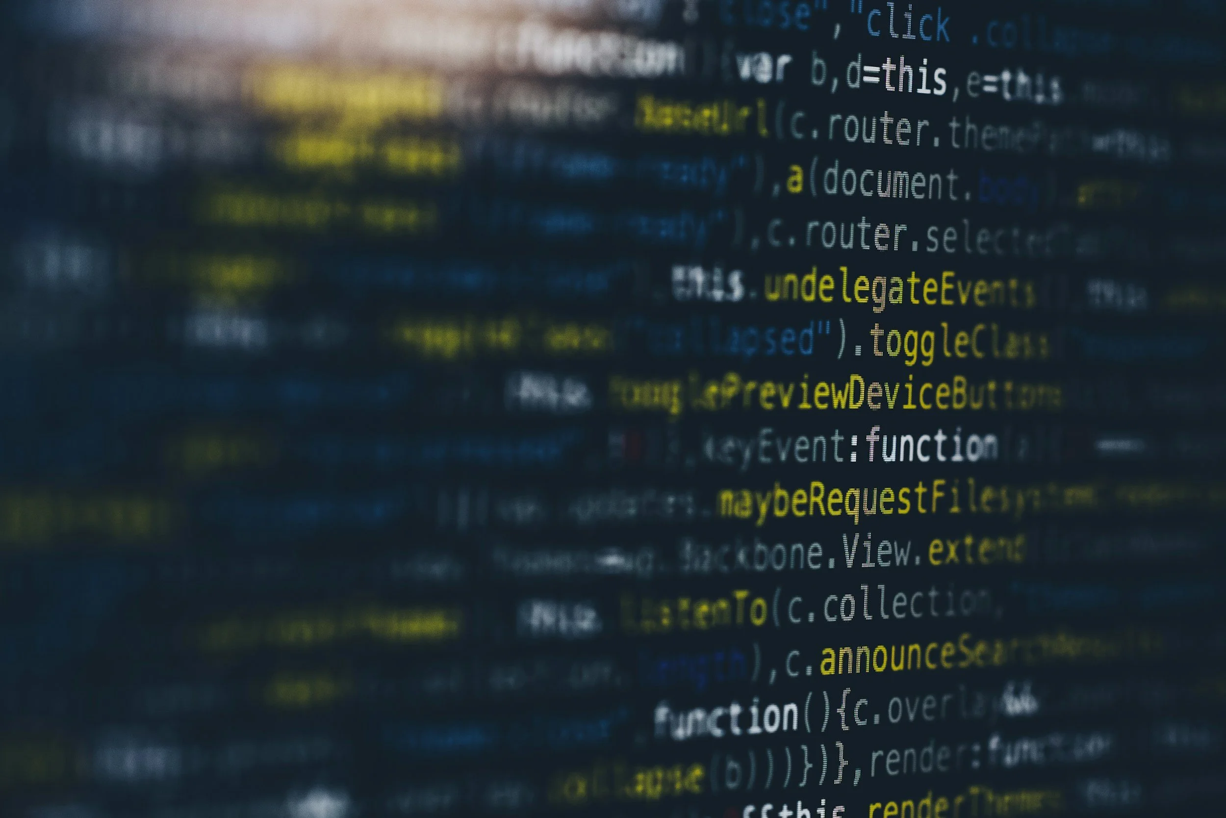 Close-up of colored programming code on a screen, showing syntax highlighting with keywords and functions in different colors.