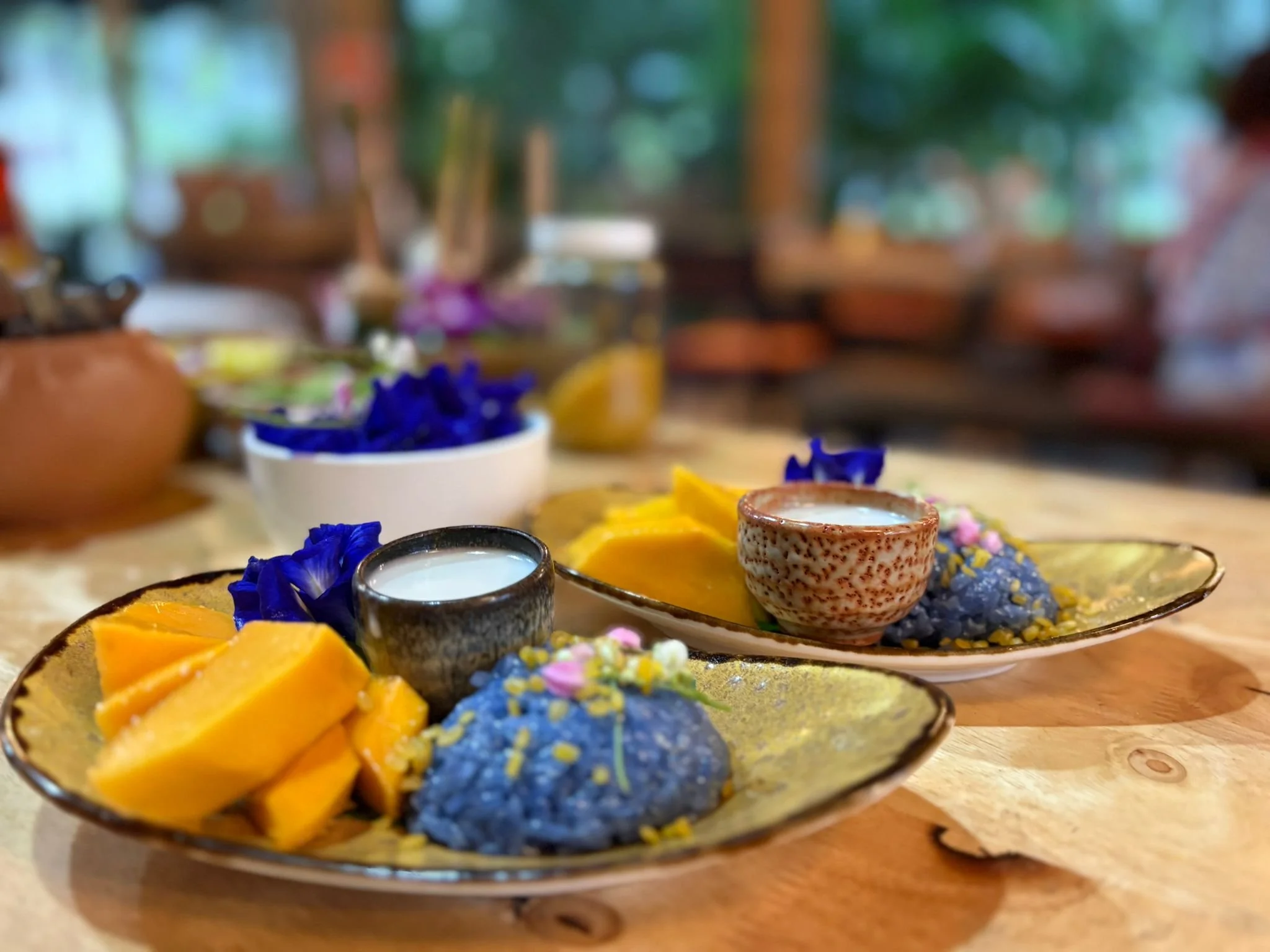 Mango sticky rice with butterfly pea rice, a classic Thai dessert from our cooking class