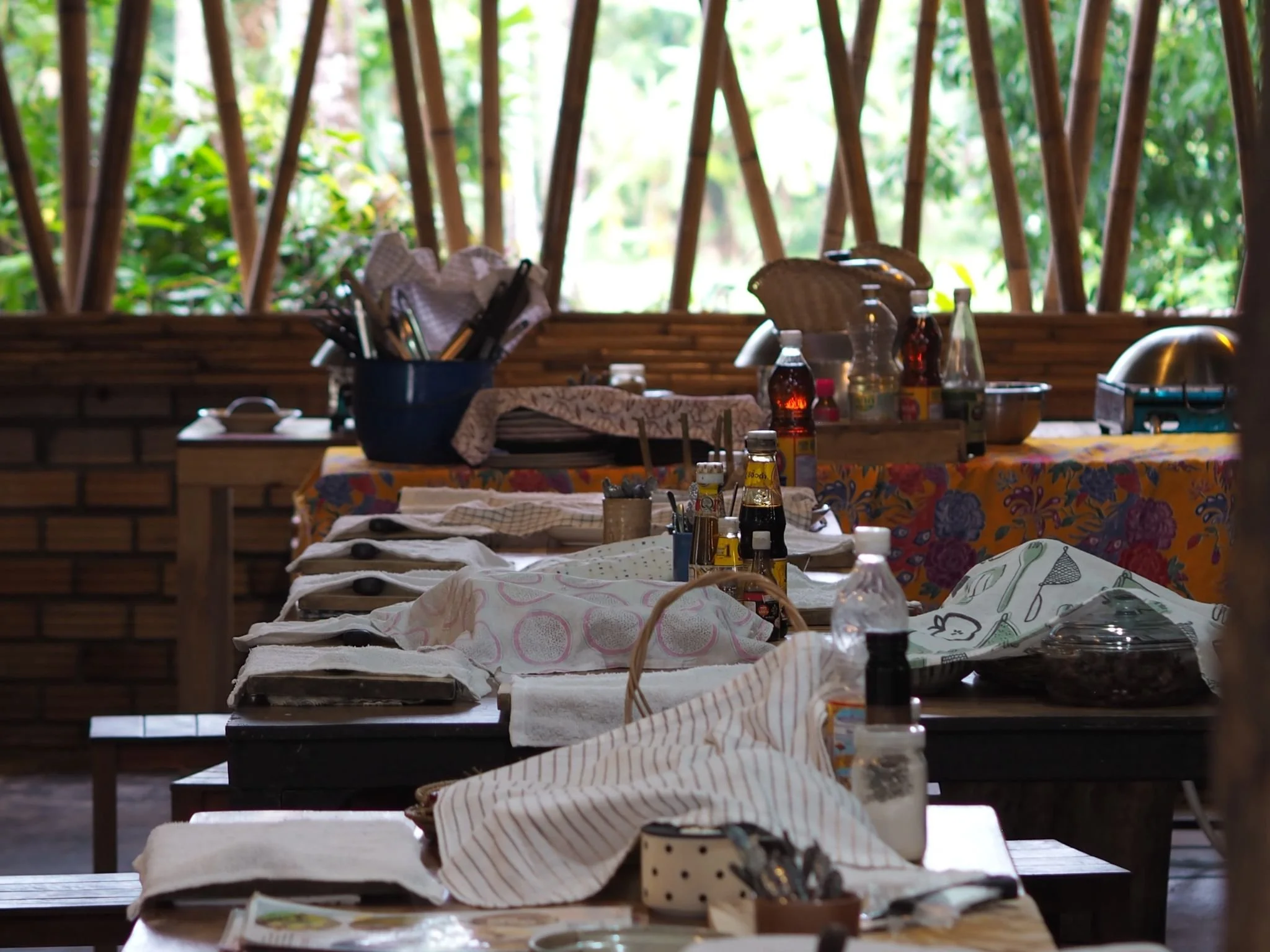 Open-air cooking classroom with prepared workstations at Proud Home, Koh Phangan