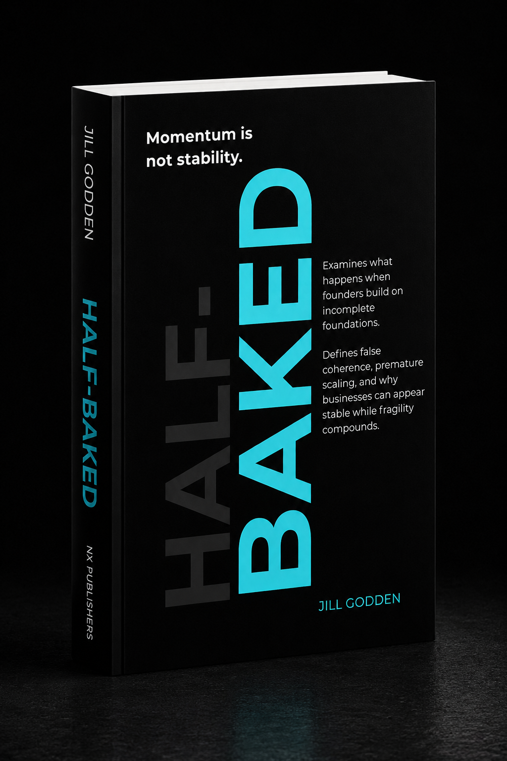 Book titled 'Half-Baked: Ahead' by Jill Godden, with a black cover and blue and white text, standing on a dark surface against a black background.