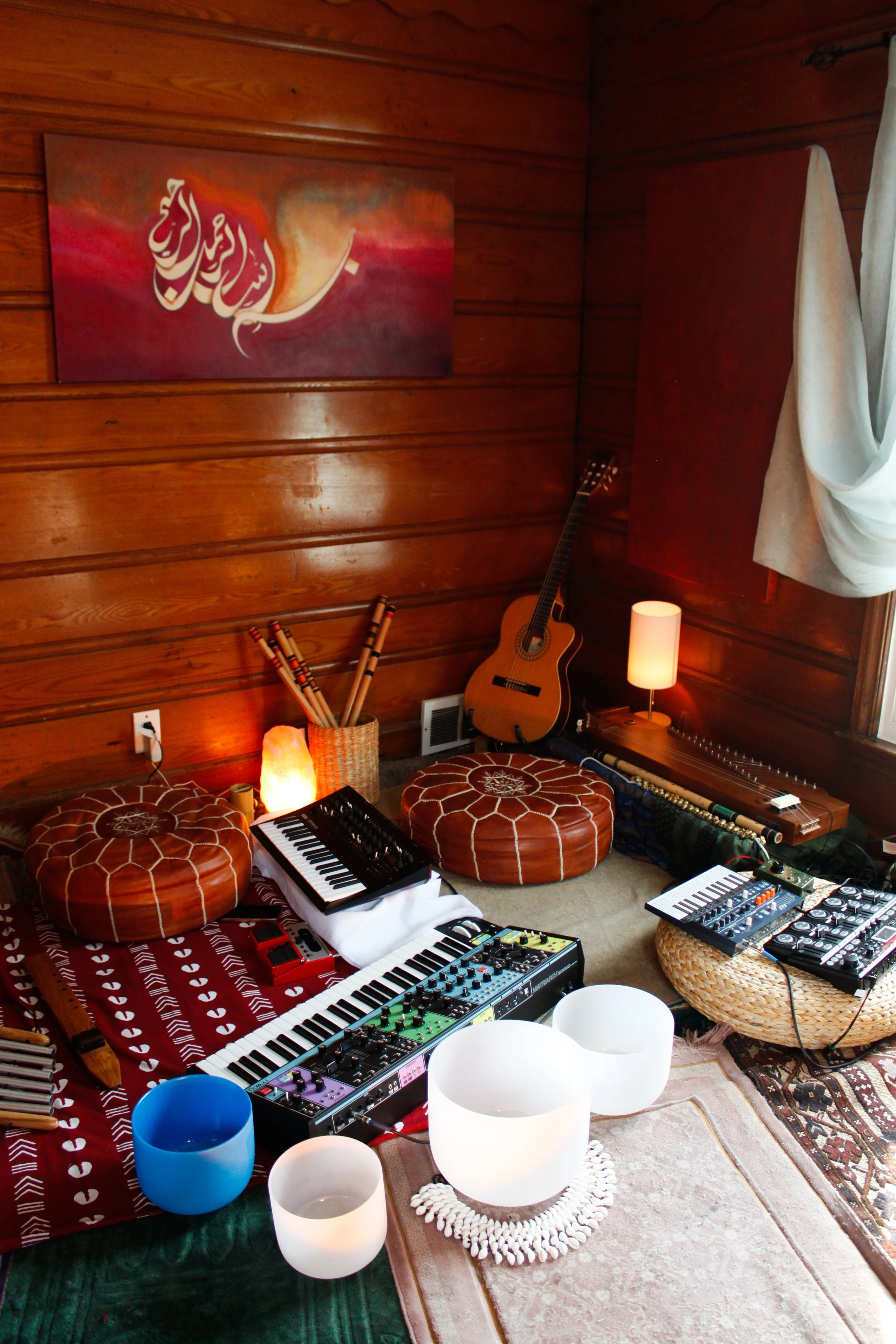 Music room with wooden walls, guitar, various musical instruments, and decorative lighting.