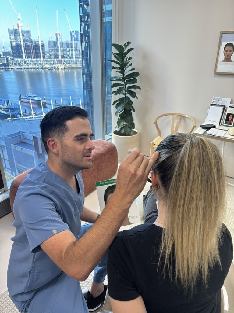 Carl Elliot, registered nurse and aesthetician, in clinic consultation