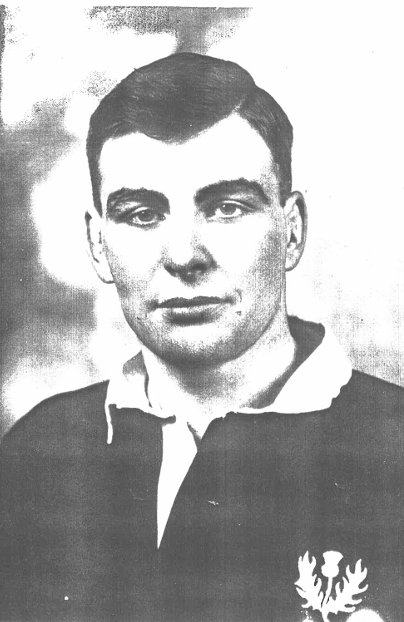 Black and white portrait of a young man in a sports jersey with an eagle emblem on it.