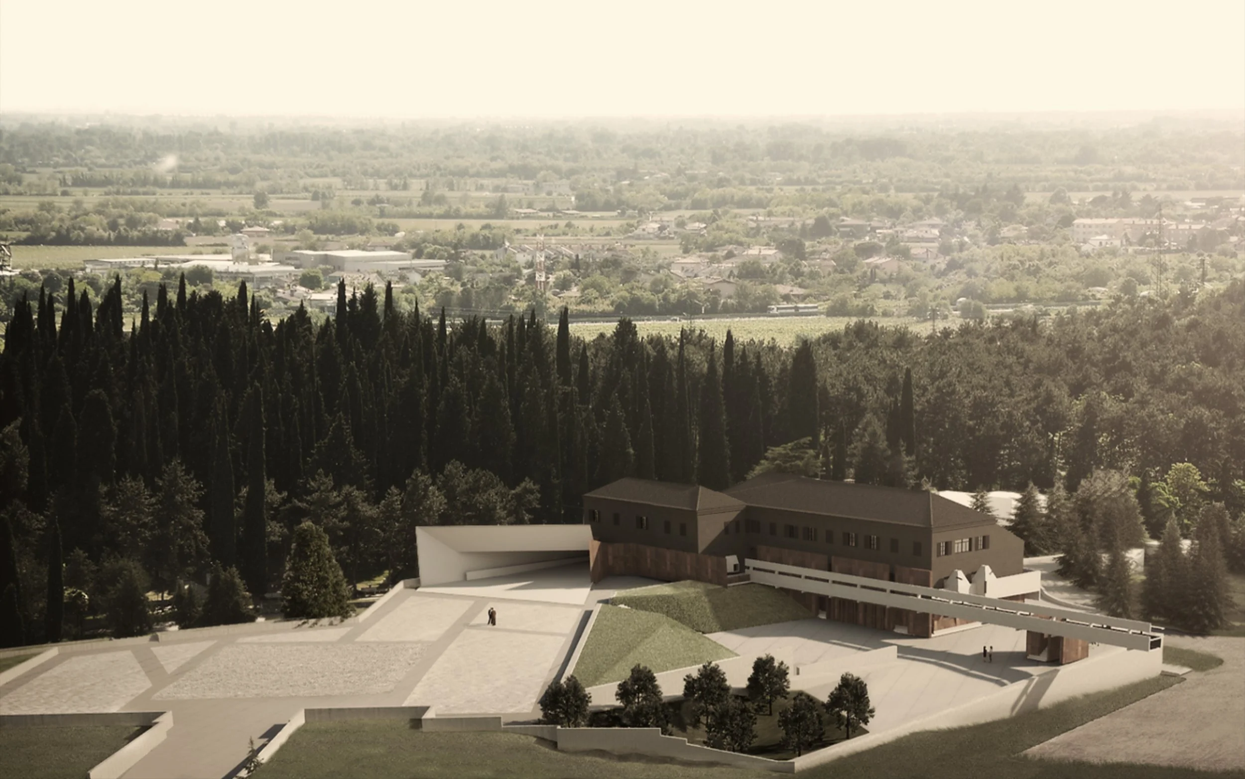 Aerial view of a landscape with trees, buildings, and farmland extending to the horizon under a hazy sky, with a modern architectural building in the foreground.