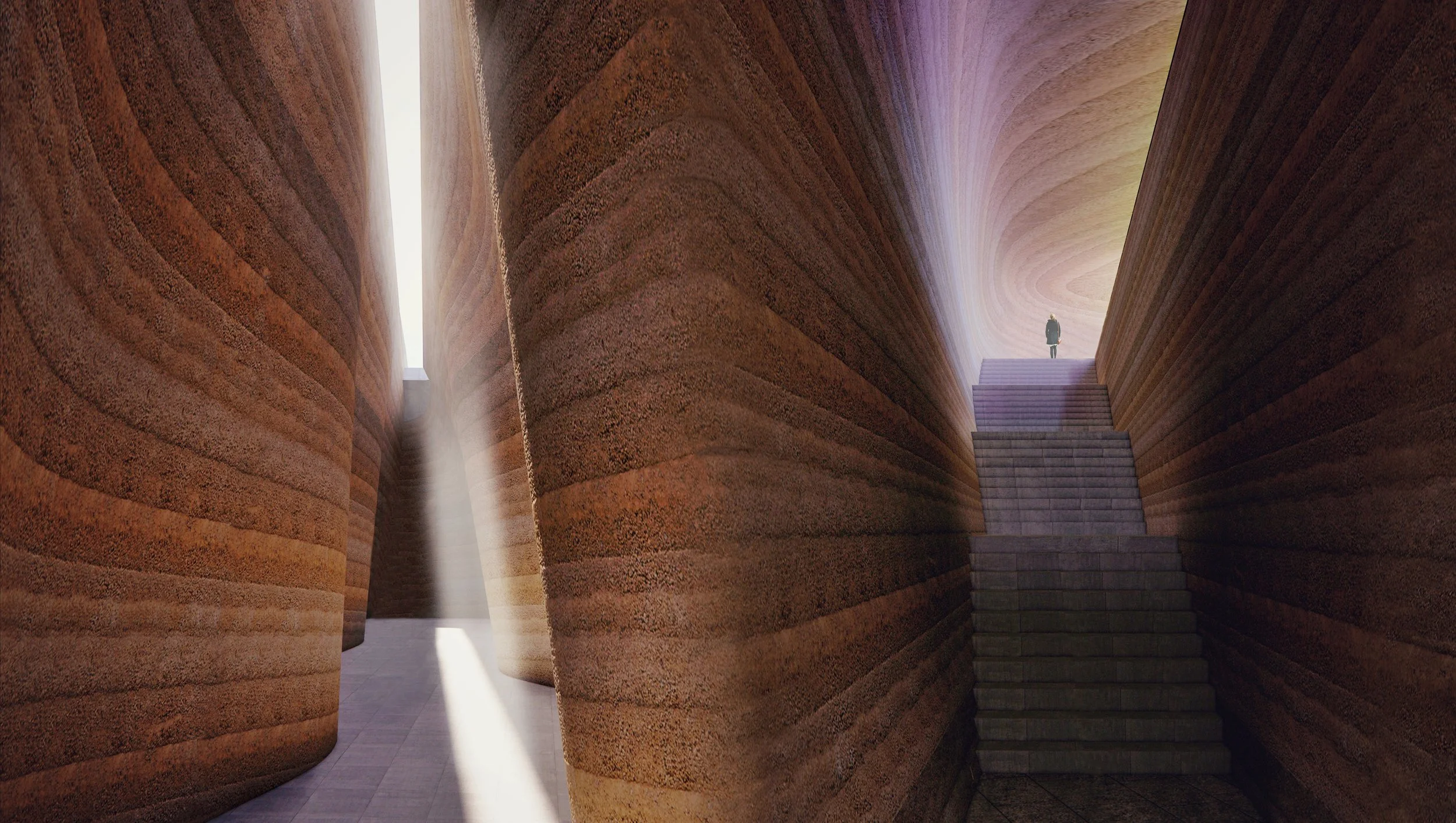 A person standing on stairs at the top of a modern, curved architectural interior with textured, reddish-brown walls and a beam of natural light.