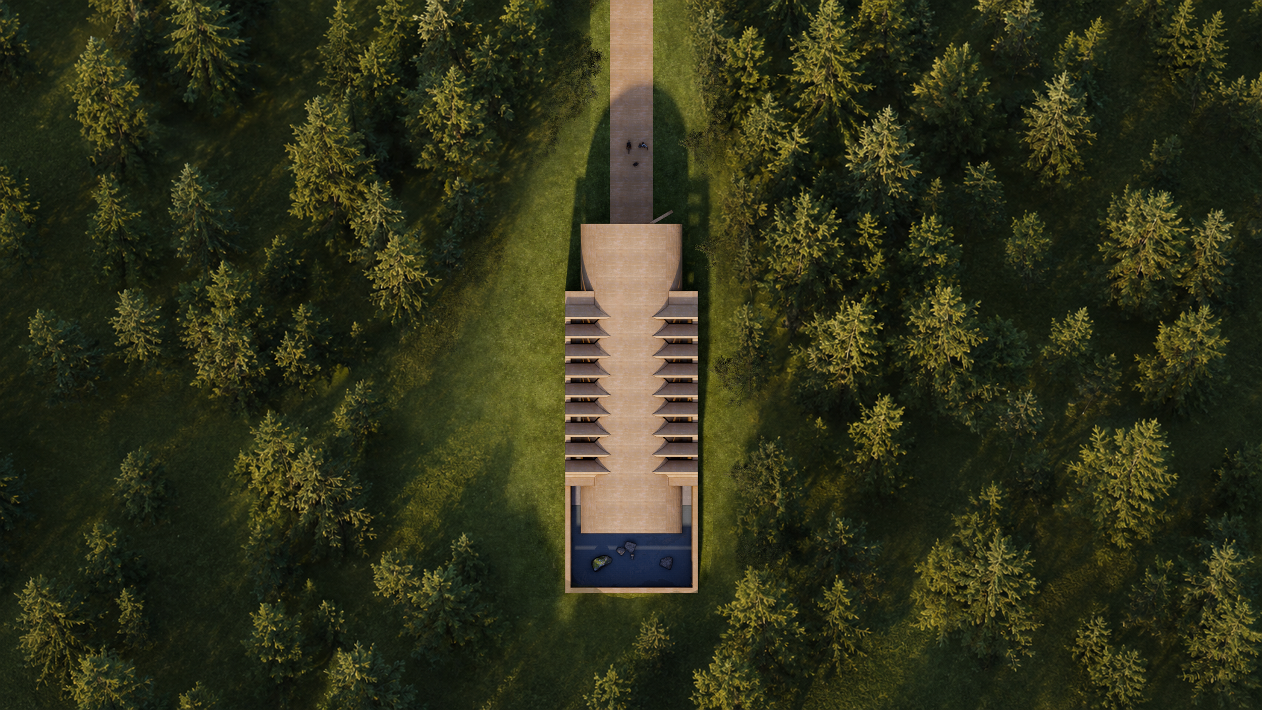An aerial view of a modern building with multiple balconies, surrounded by dense forest with tall trees.