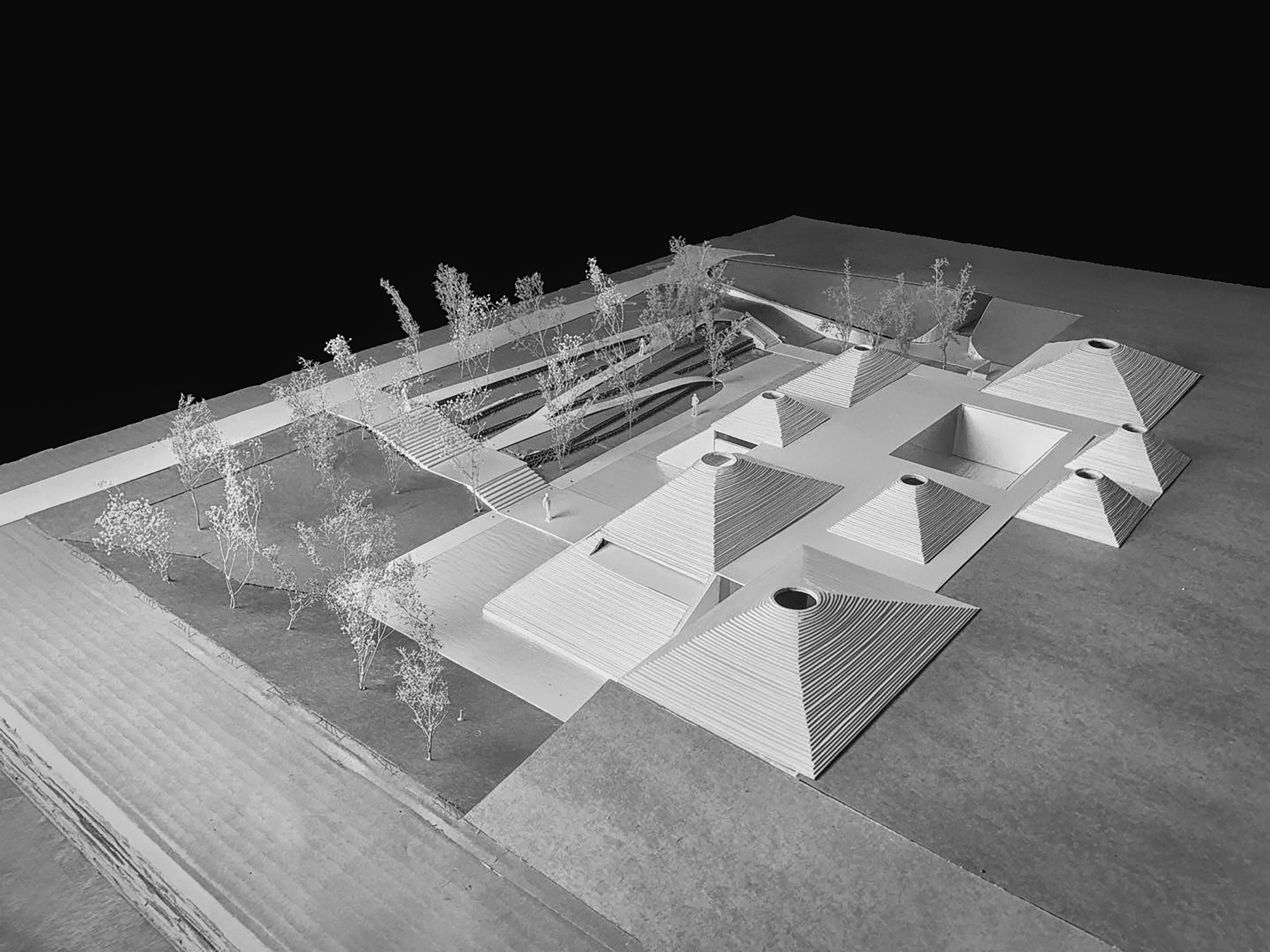 Architectural model of a building with trees and outdoor steps in black and white.