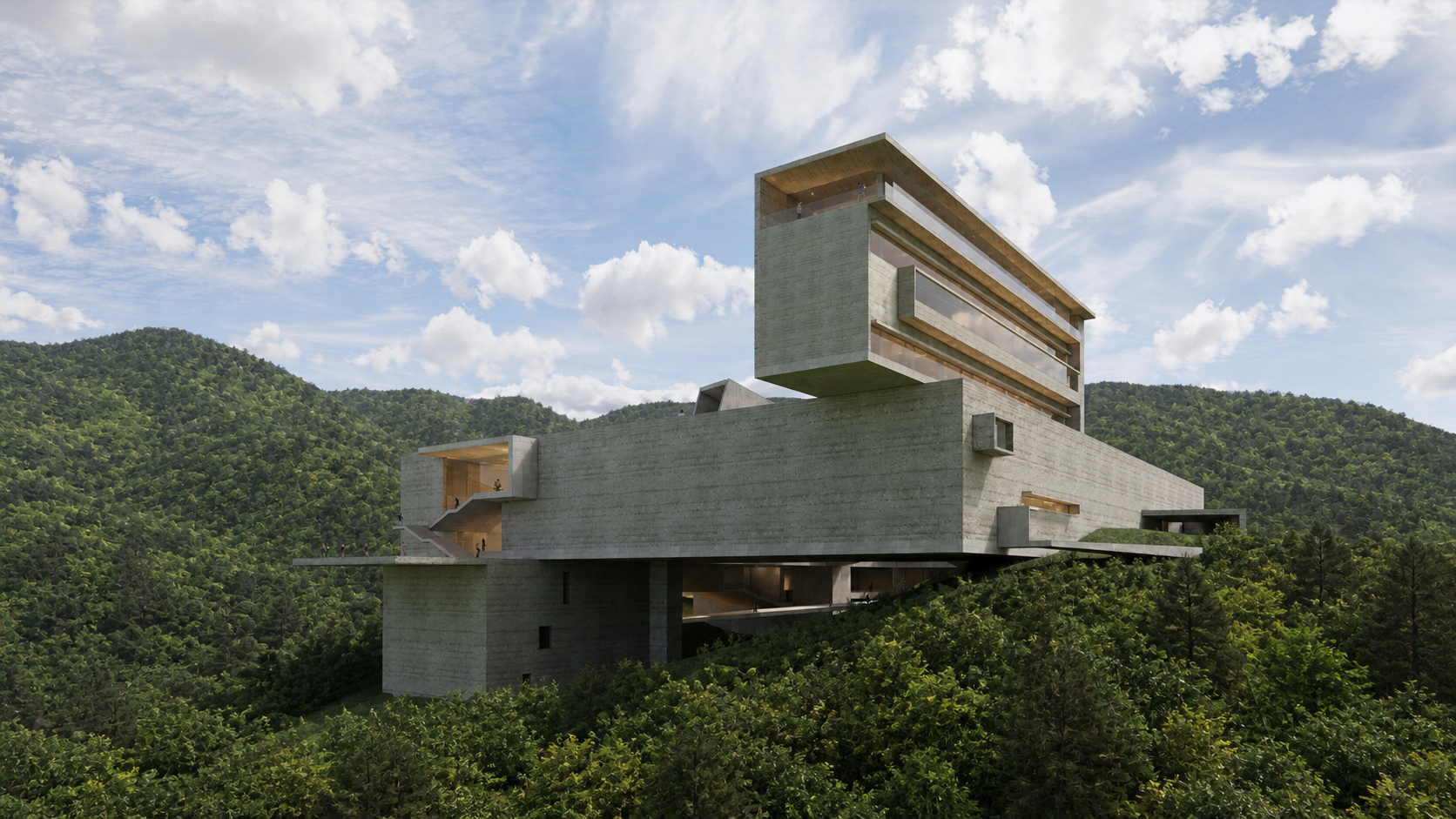 Modern multi-story concrete building with large glass windows, built on a hillside surrounded by green trees, under a partly cloudy sky.