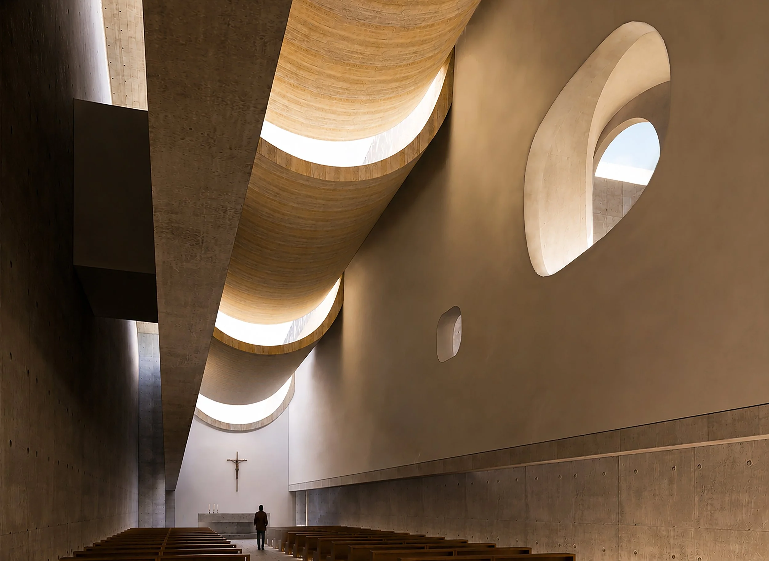 Interior of a modern church with curved wood and concrete architecture, a crucifix on the wall, and a person standing at the front.