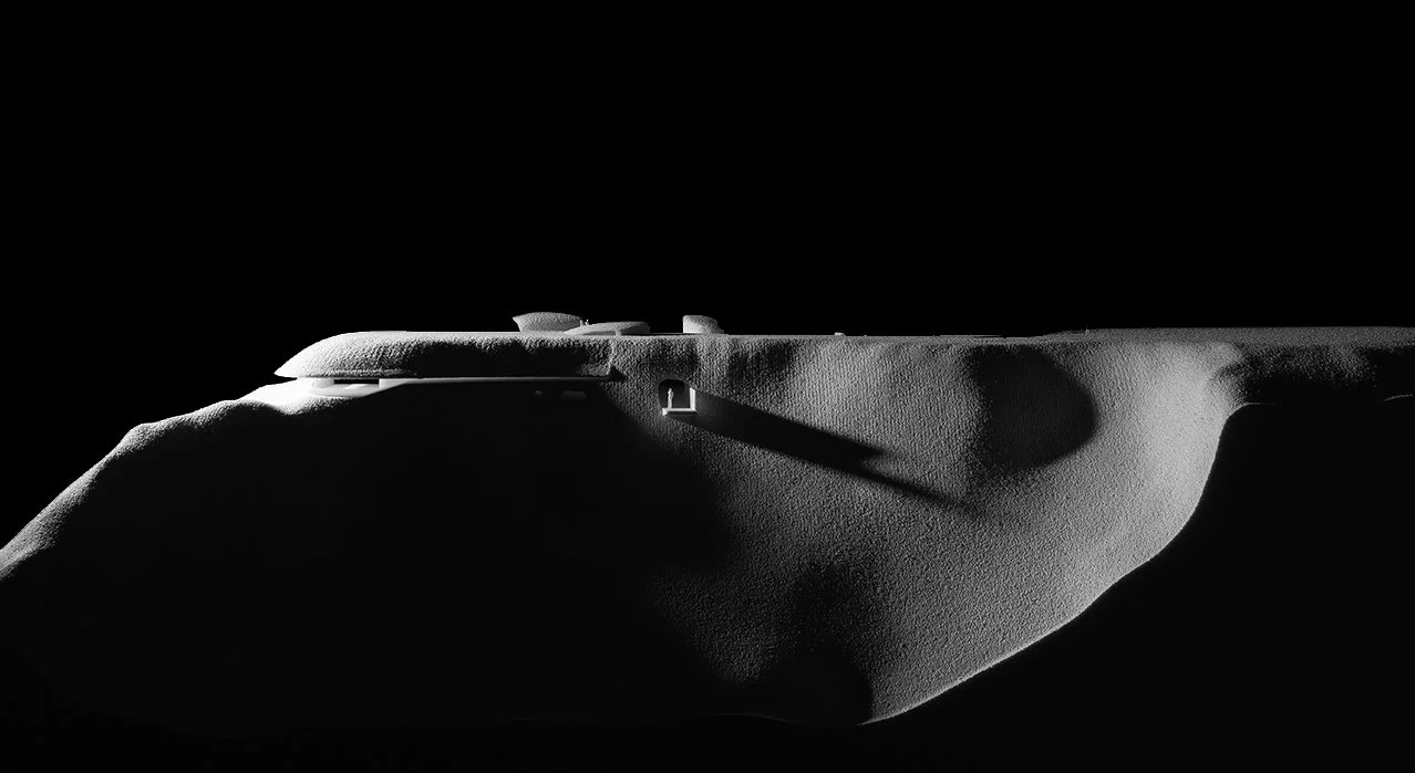 Side view of a toy spaceship with shadows on its surface, against a black background.