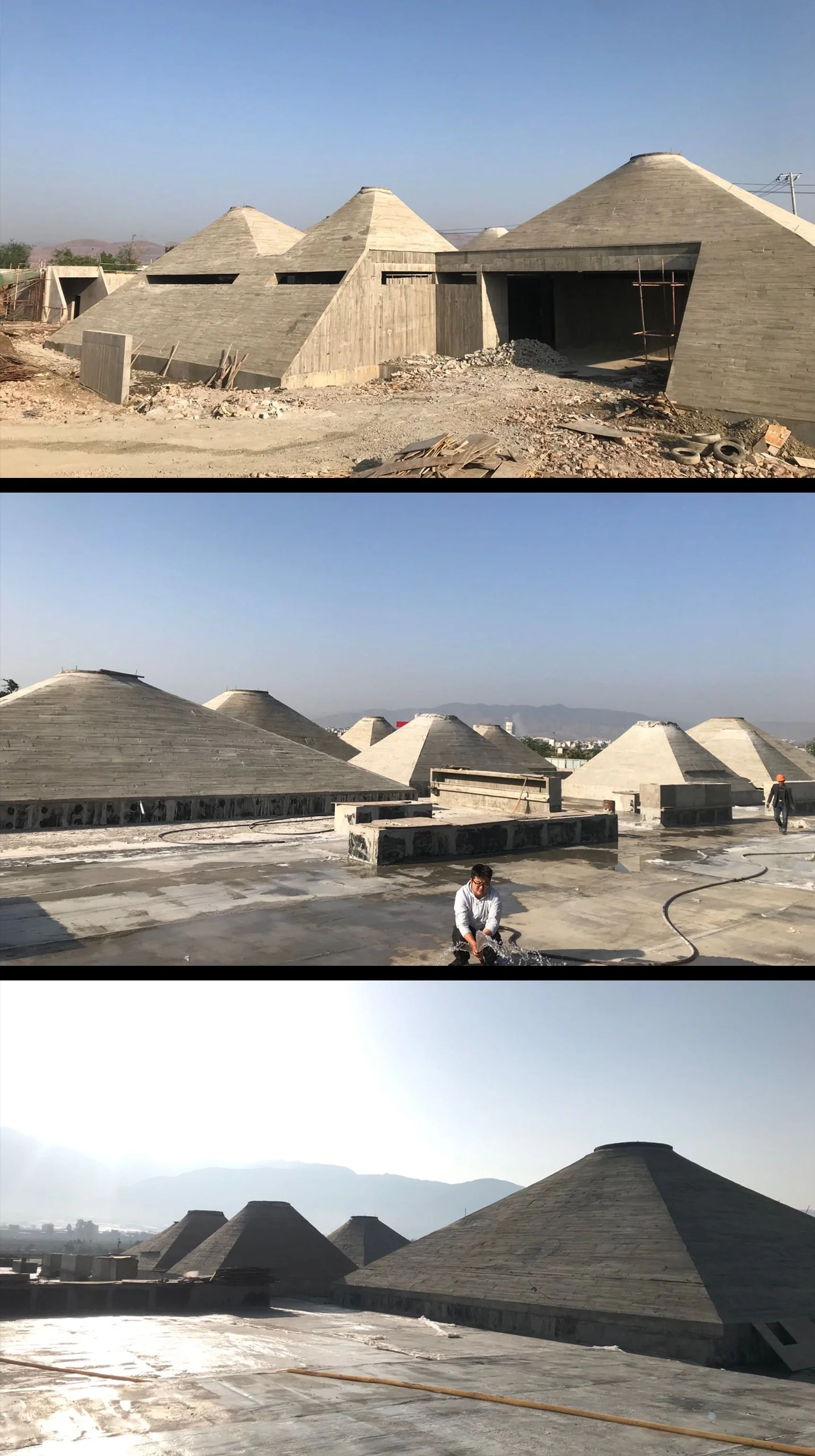 Construction site featuring multiple cone-shaped roofs in various stages of completion, with workers and construction materials scattered around.