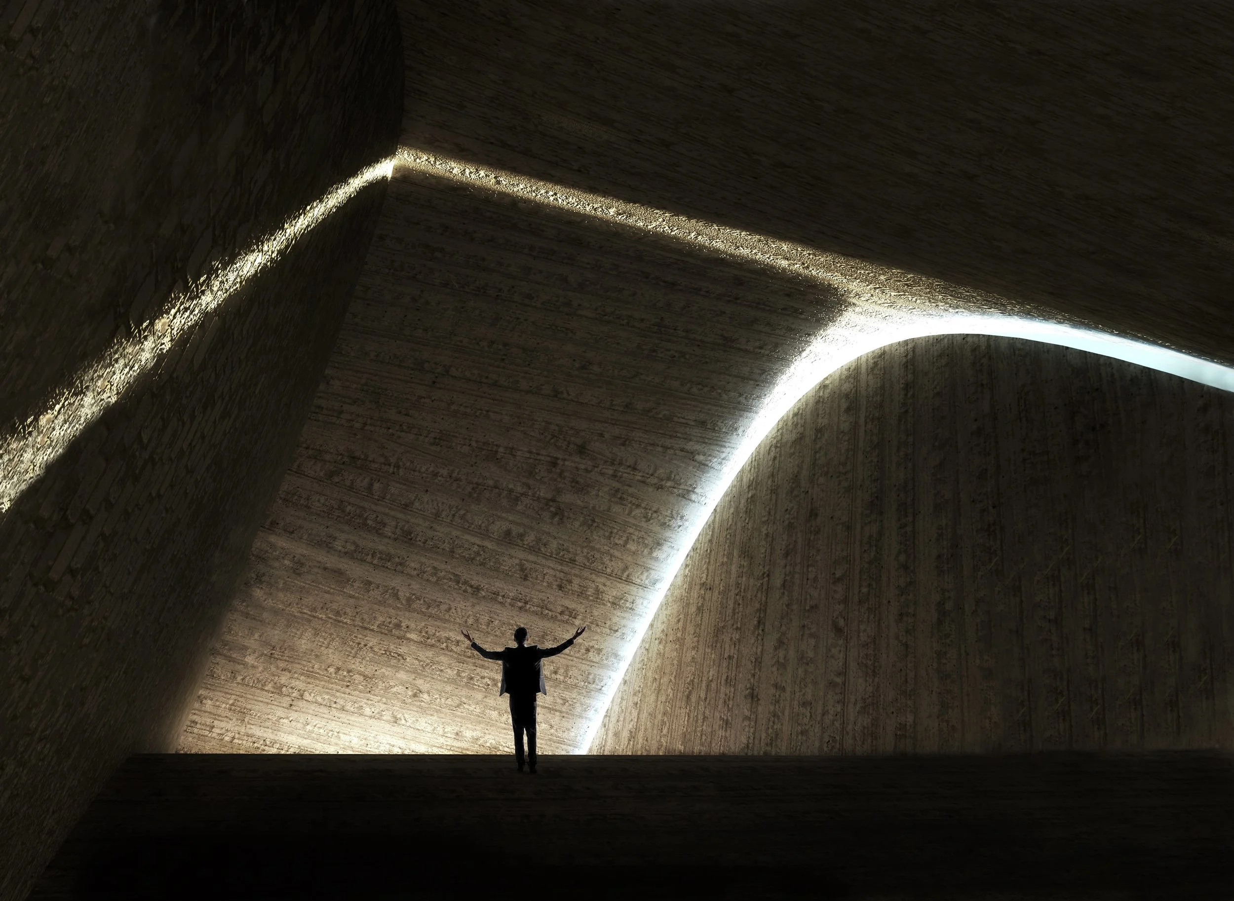 Person standing inside a large, architecturally modern concrete structure with curved walls and ceiling, illuminated by concealed lighting, with arms raised.