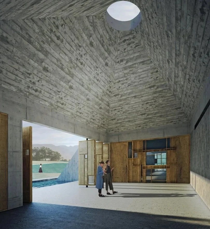 Interior of a modern building with a high, textured concrete ceiling, wooden walls with built-in shelves, and two people standing and talking in the center, with an open doorway revealing an outdoor scene with trees and mountains.