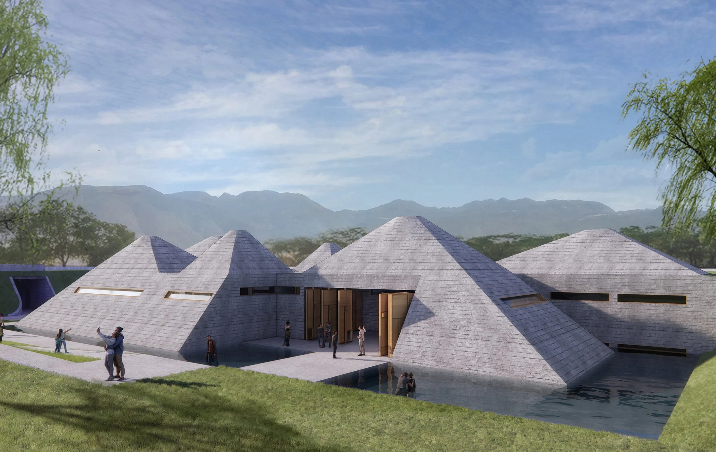 A modern architectural building with multiple cone-shaped rooftops, large open doorways, and surrounding water features, set against a mountainous backdrop with trees and a partly cloudy sky.
