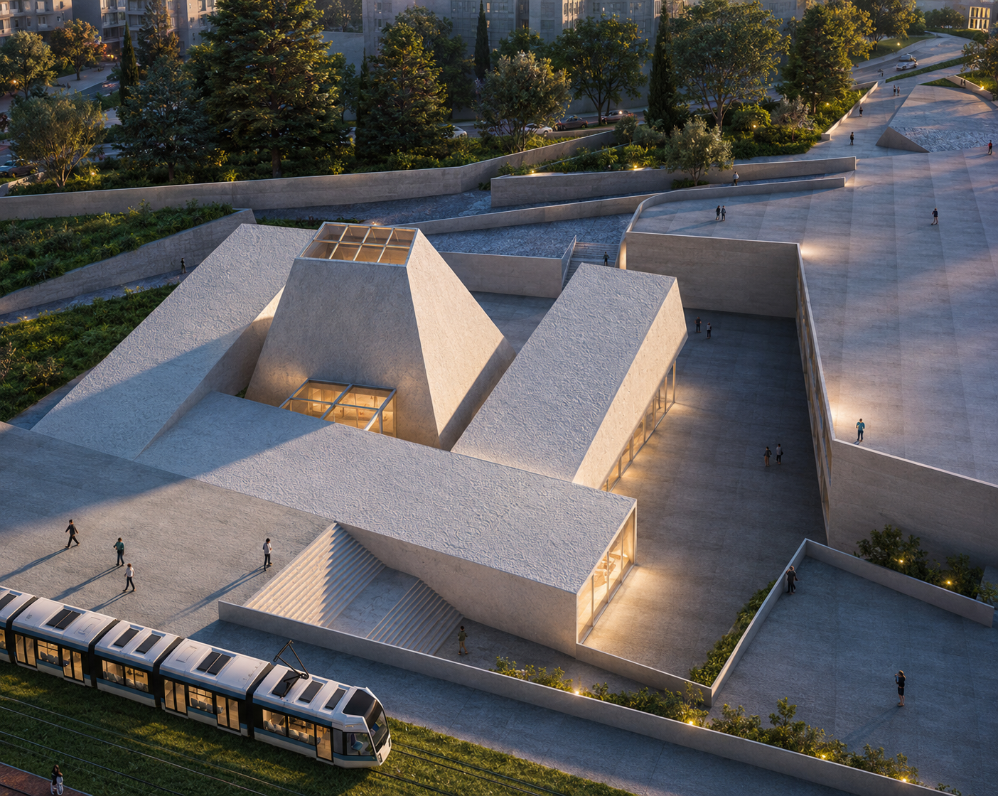 Aerial view of a modern architectural structure featuring angular, textured concrete buildings with glass skylights, situated in an urban park with trees, pathways, and a light rail train passing in the foreground at dusk.