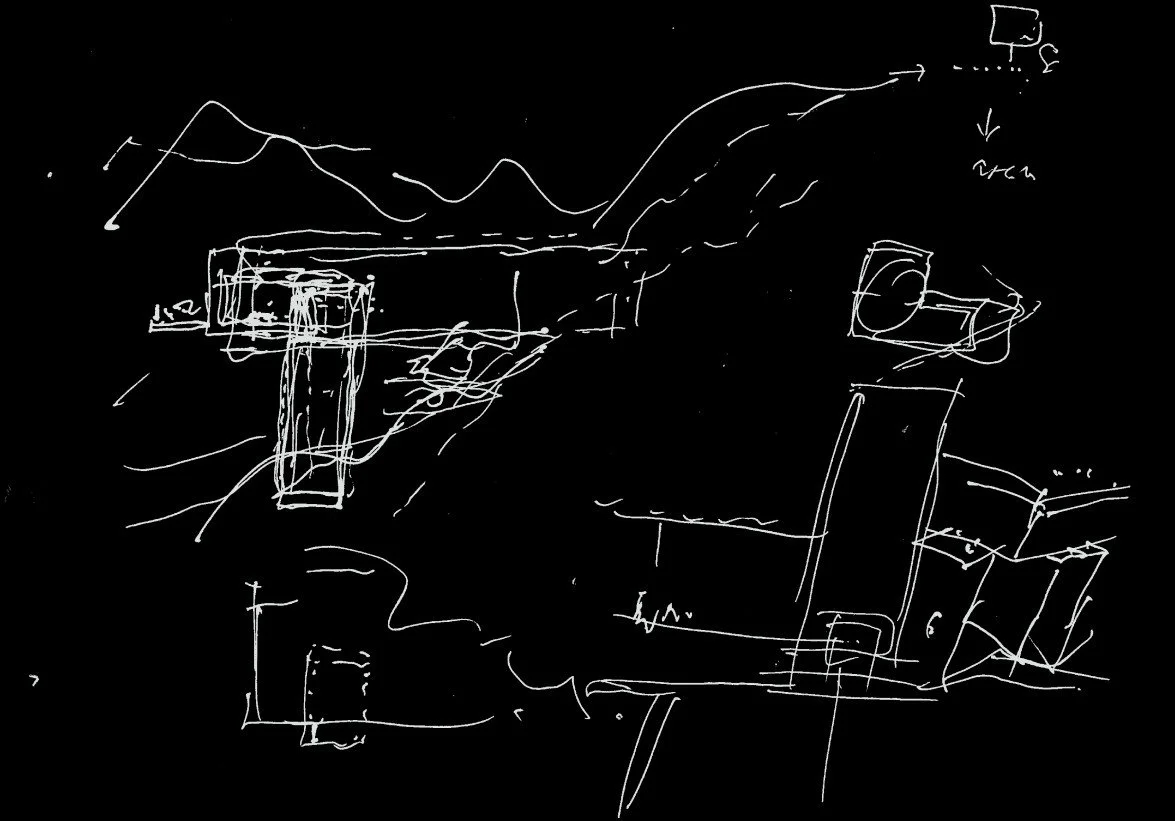 Sketch of a landscape with mountains in the background, featuring various architectural structures, including rectangular and cylindrical buildings, drawn in white lines on a black background.