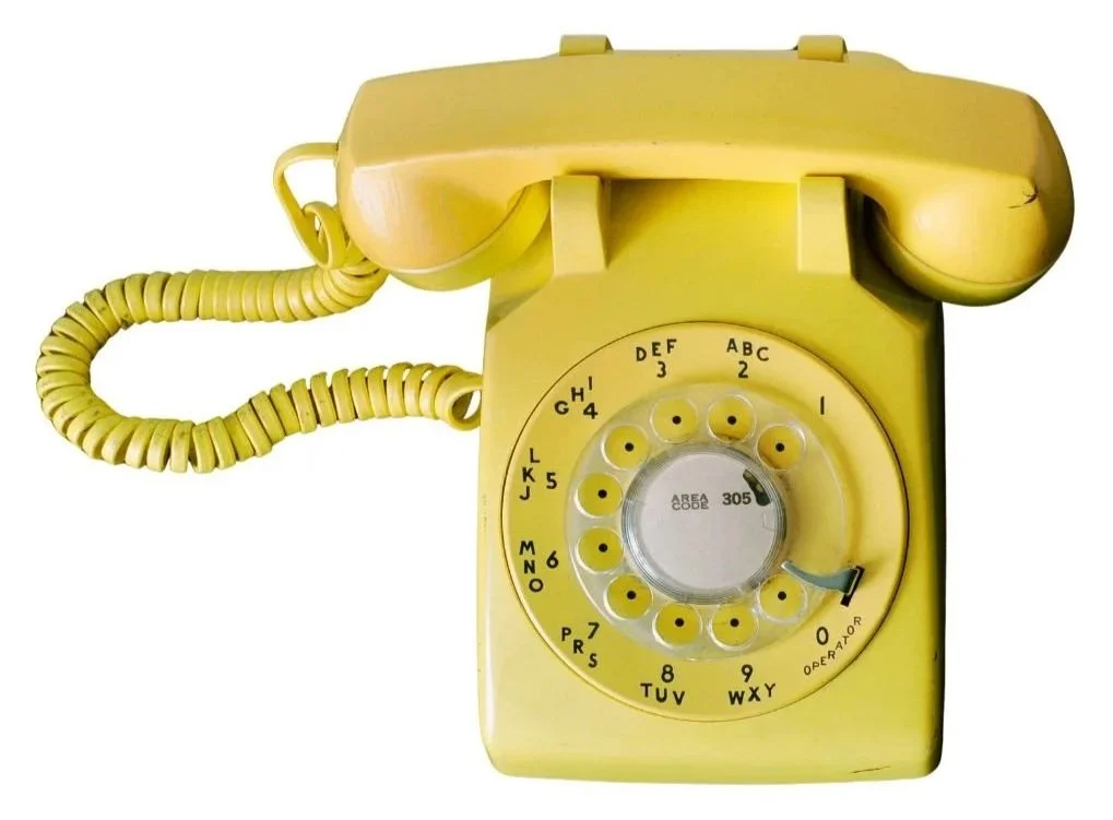 a yellow telephone suggesting that people have to call me for a collab