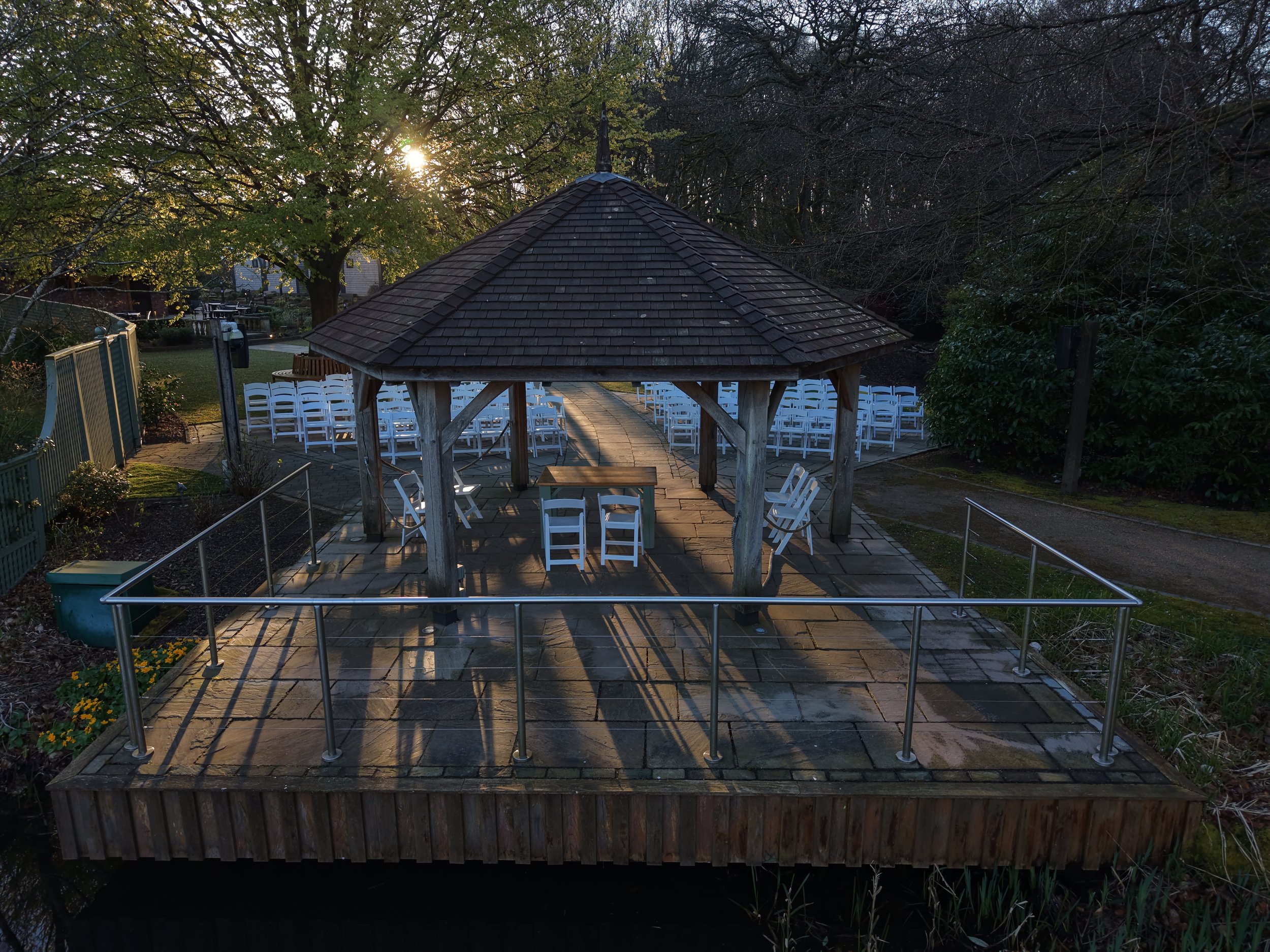 Aerial drone photograph of the outdoor summer house wedding ceremony area at Moddershaw Oaks wedding venue