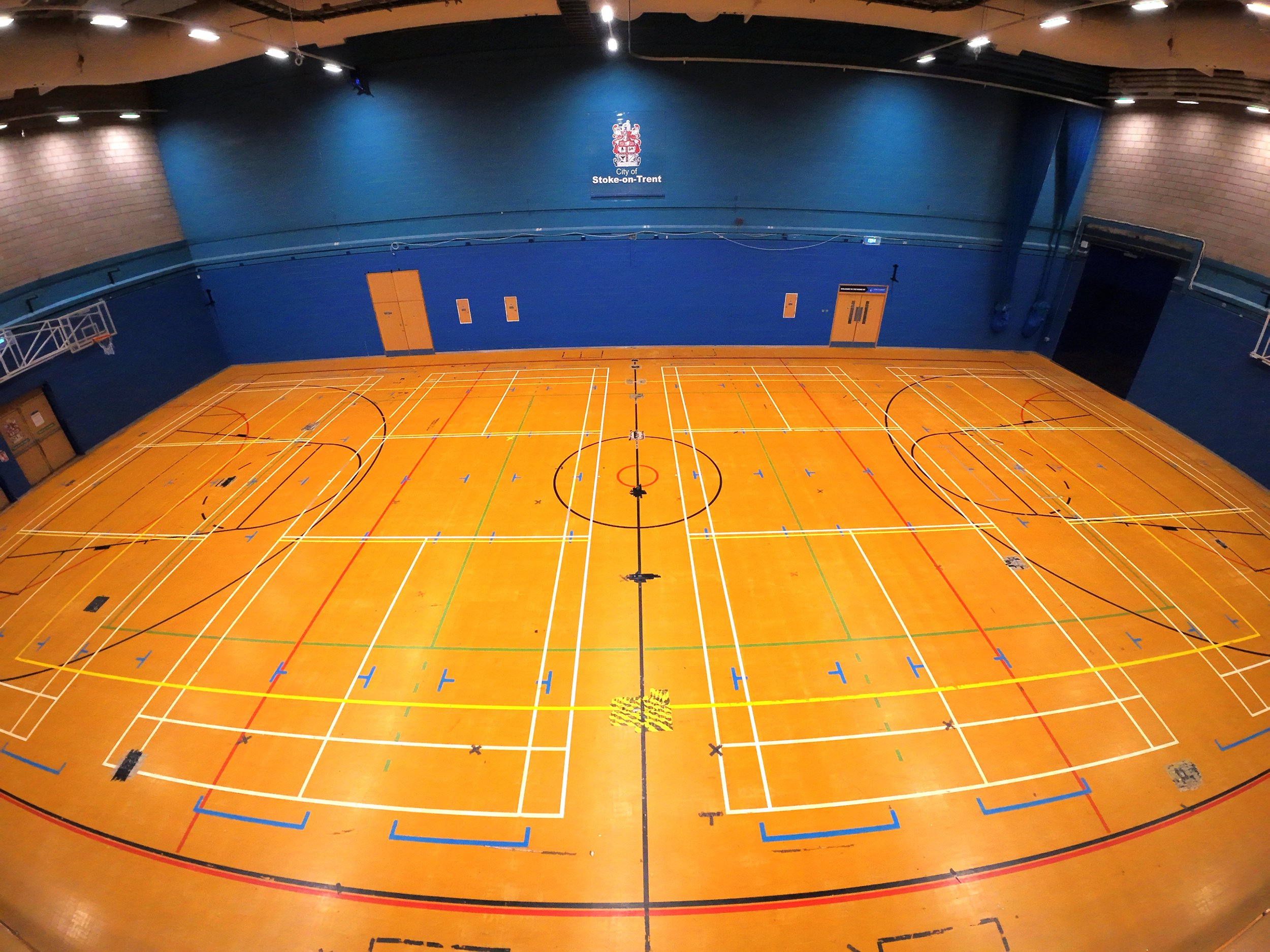 Aerial drone photography inside the large sports hall at Fenton Manor Sports Complex, showcasing venue scale for events