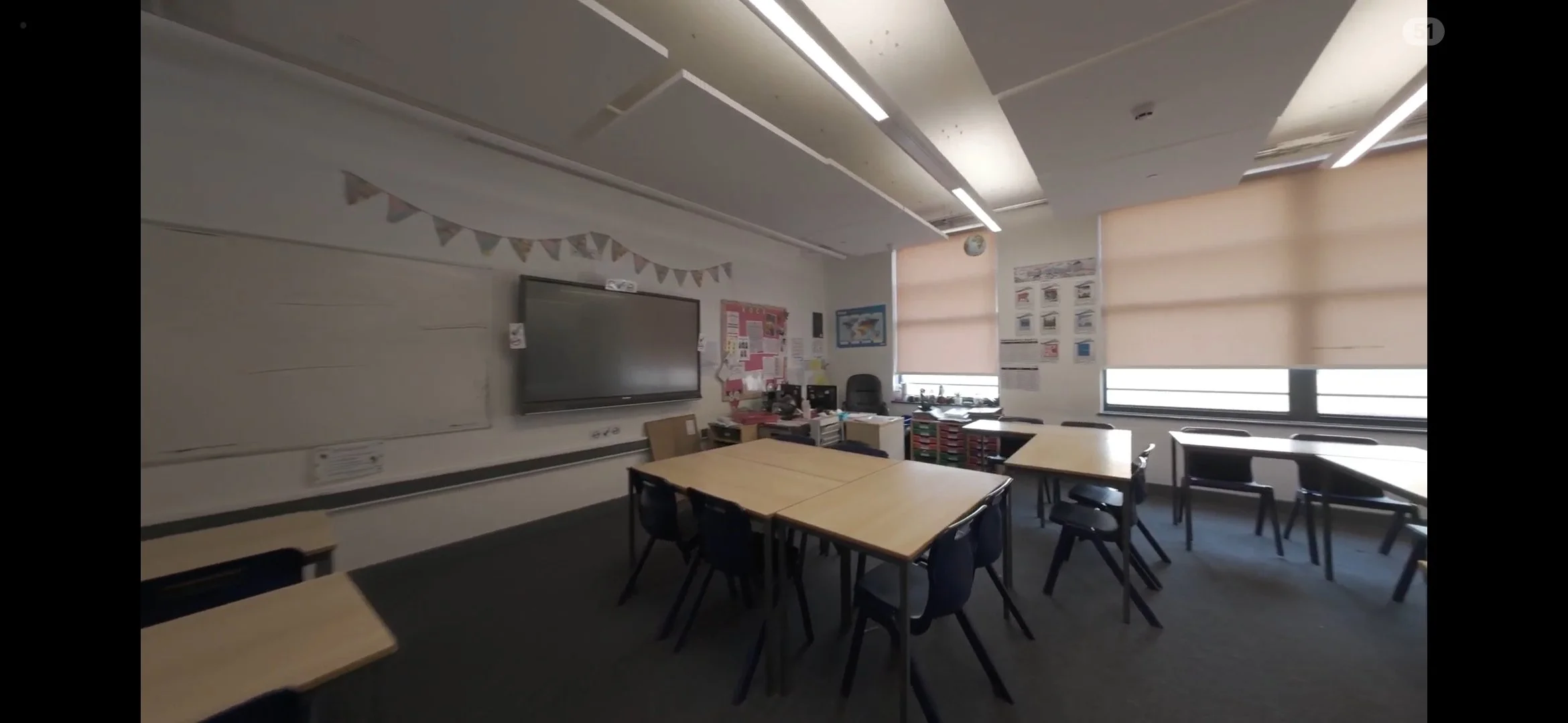 Indoor FPV drone filming inside a school classroom using controlled cinematic FPV flight