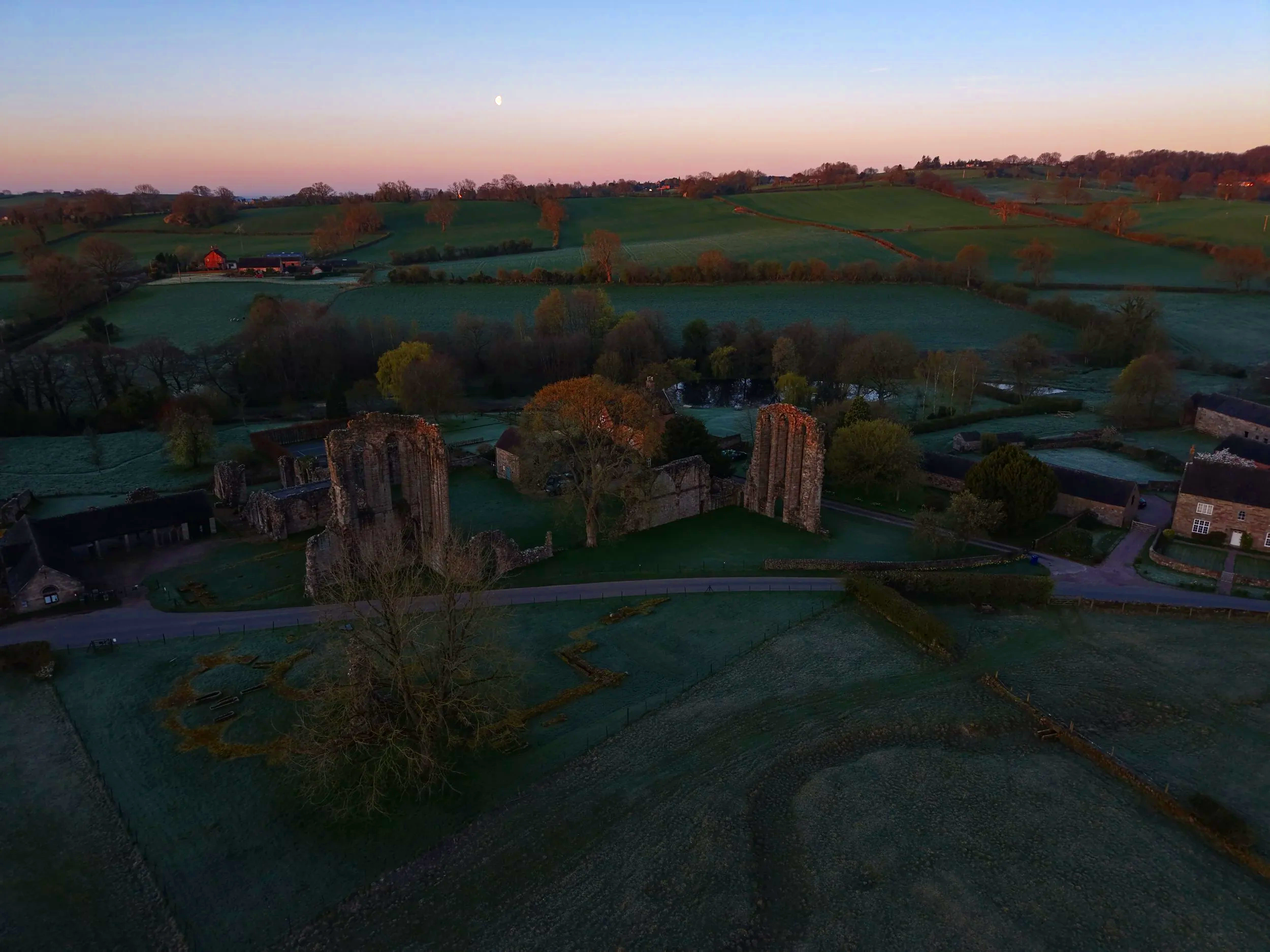 Sunrise aerial drone photograph of Croxden Abbey with the Moon visible in the sky, captured in Staffordshire
