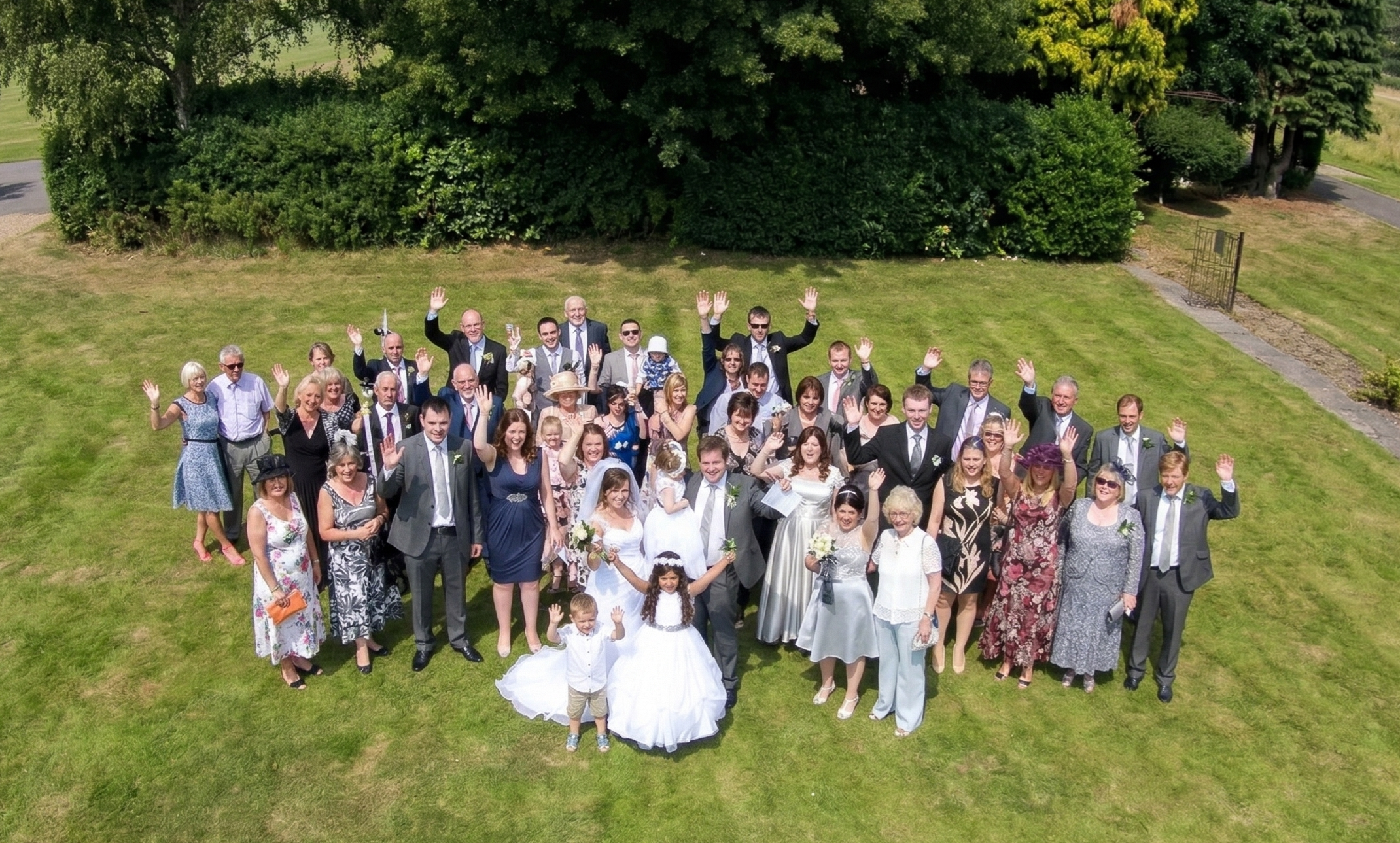 Aerial wedding drone photography capturing family and guests at a wedding venue using discreet licensed drone filming