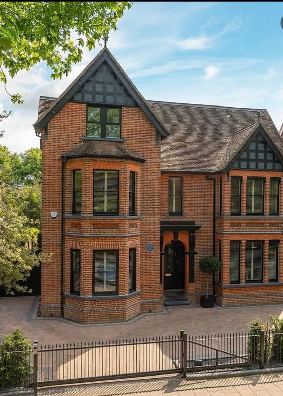 A Victorian house with pointed roofs and multiple large windows beautifully restored by the Bedford Victorian Restoration team.