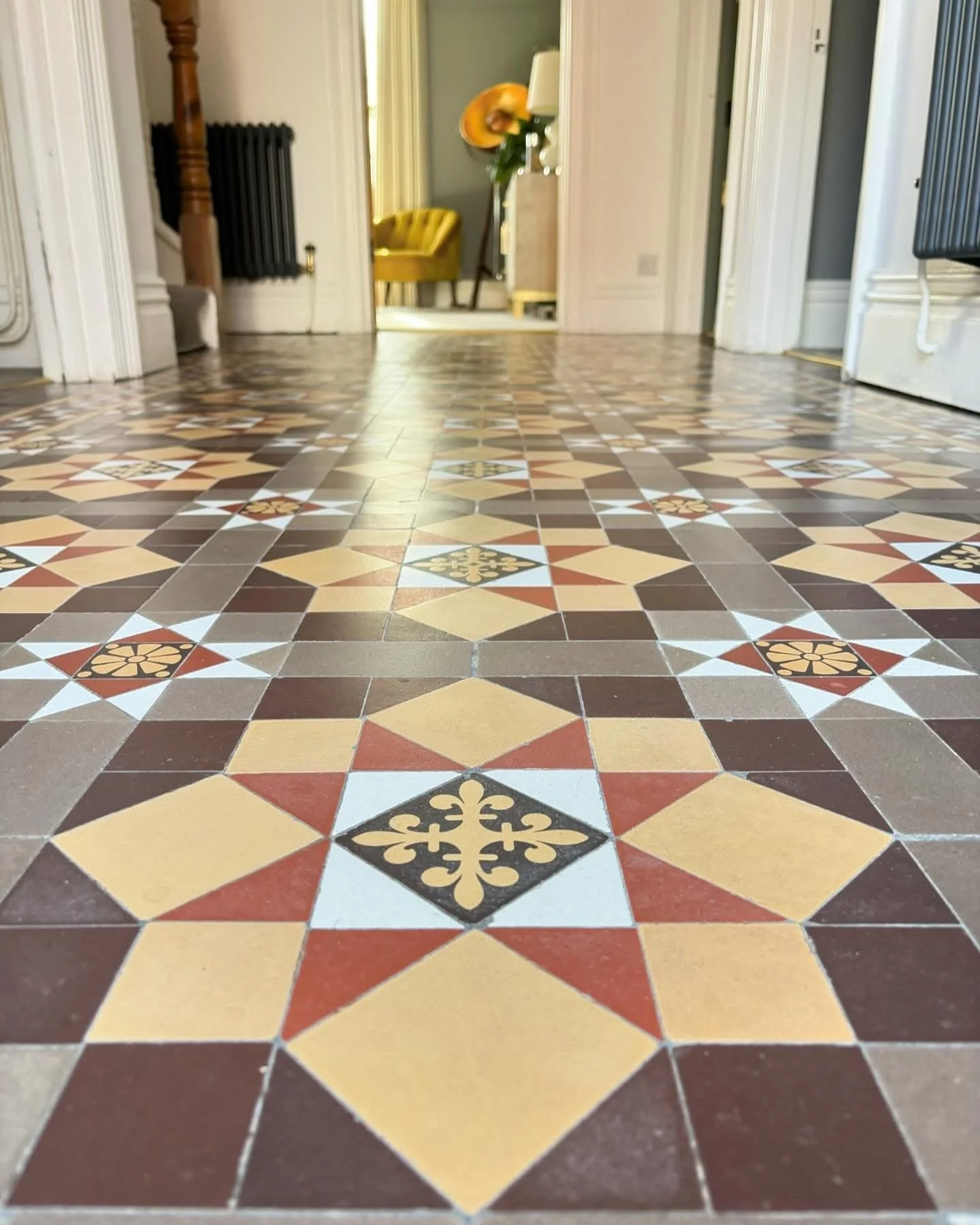 Close-up of patterned ceramic floor tiles in a Victorian house, restored by the Bedford Victorian Restoration team.