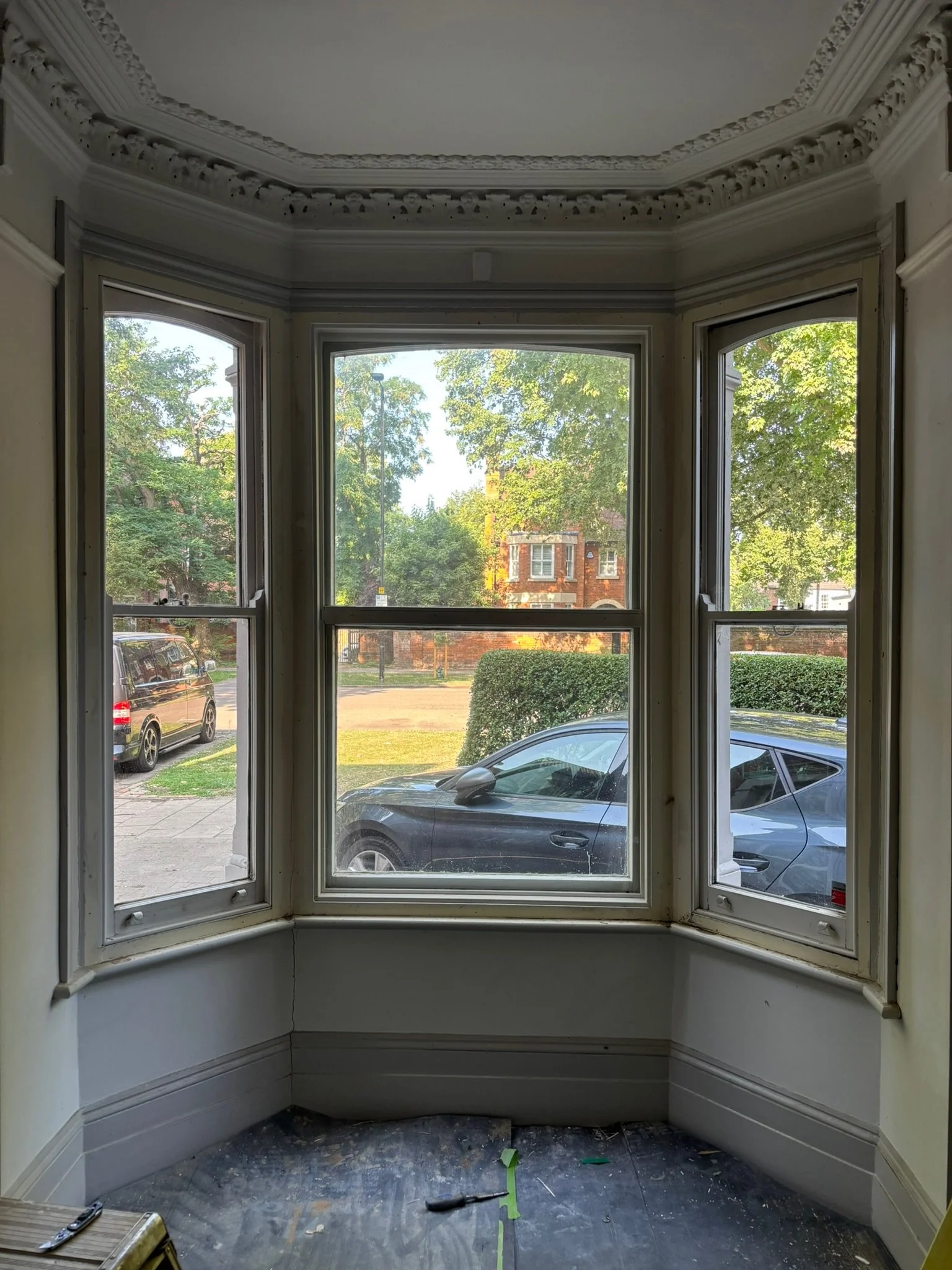 Interior of a house with a large bay window,  pre-restoration by the Bedford Victorian Restoration team.