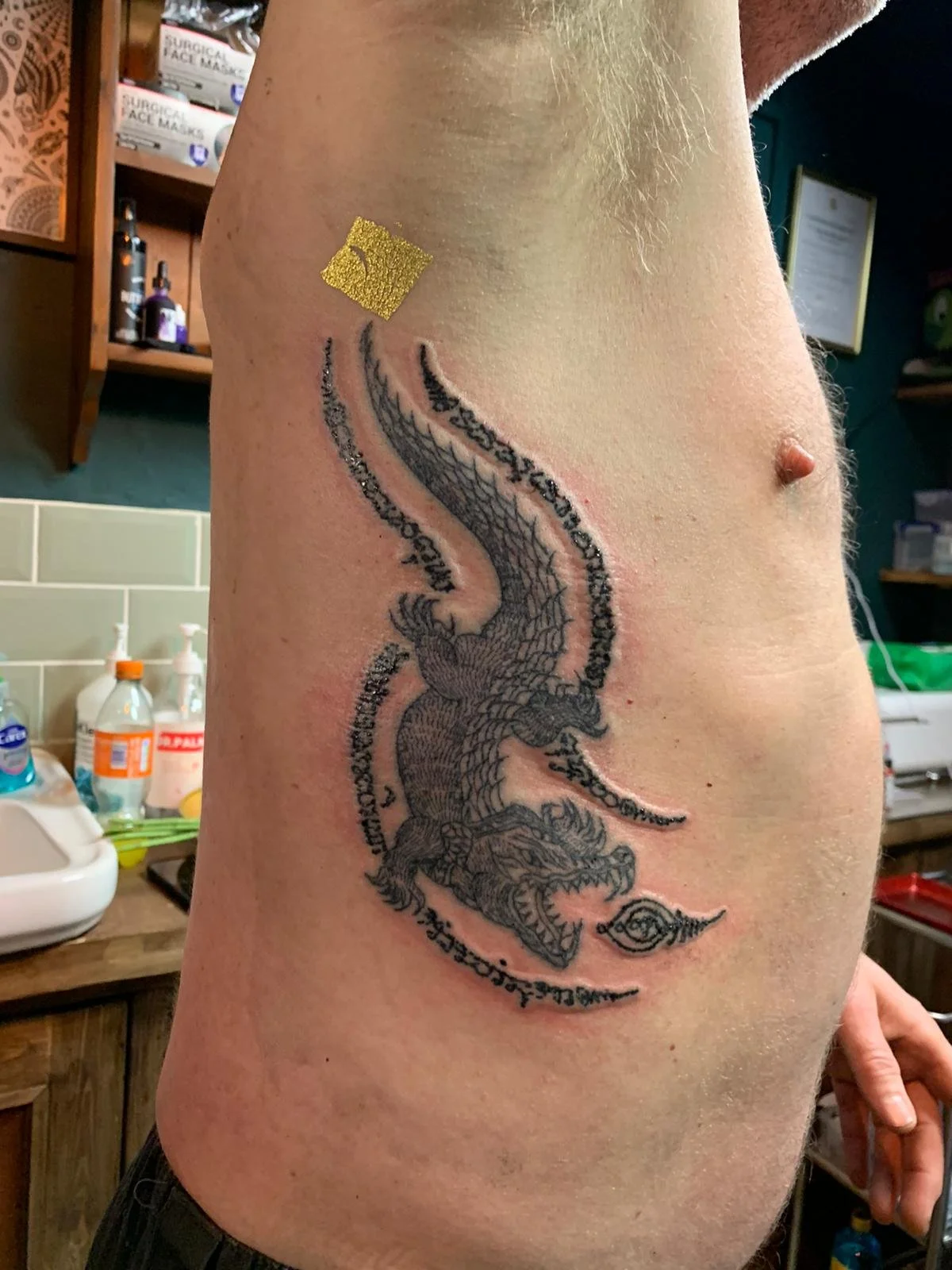 sak yant thai tattoo crocodile on ribs