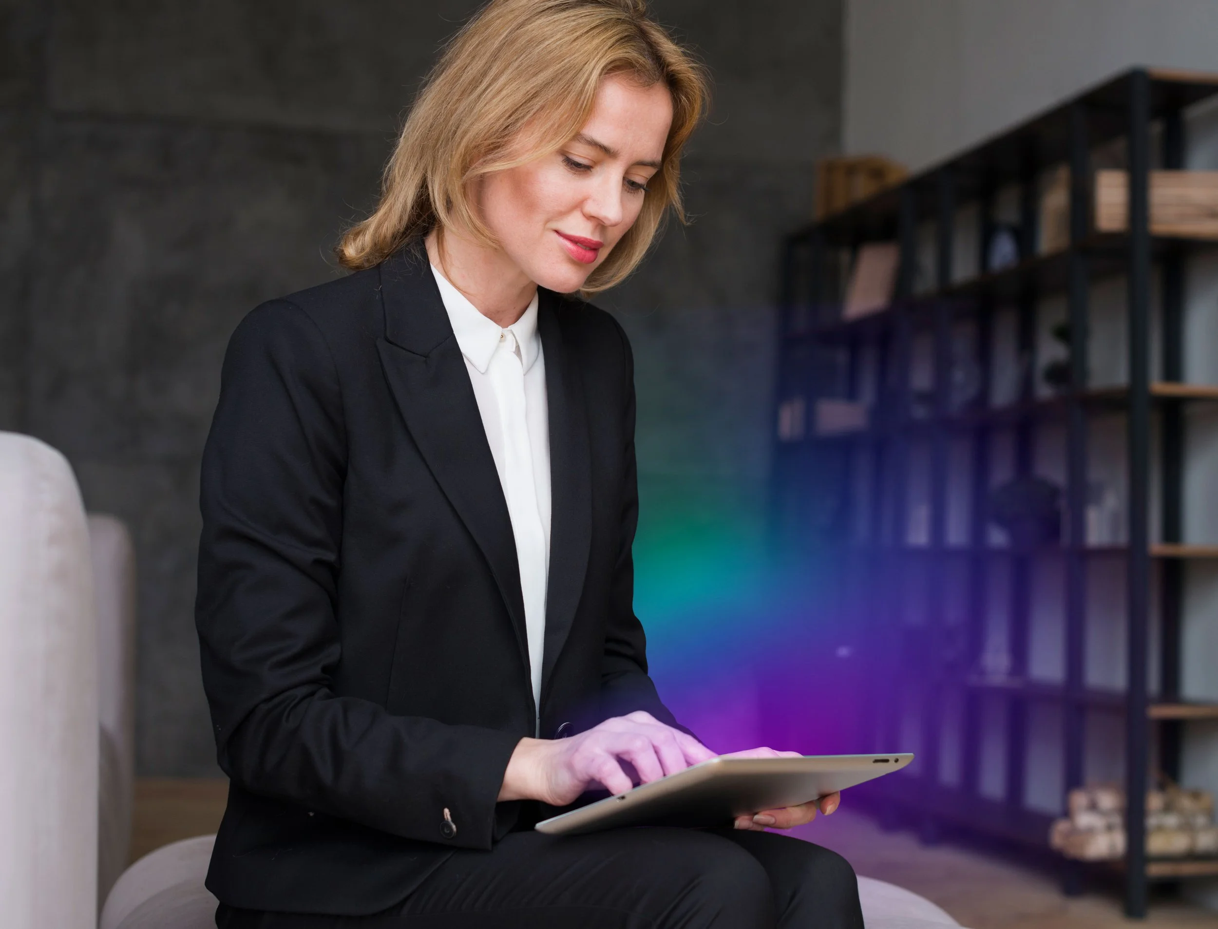blond-business-woman-sitting-using-tablet.jpg
