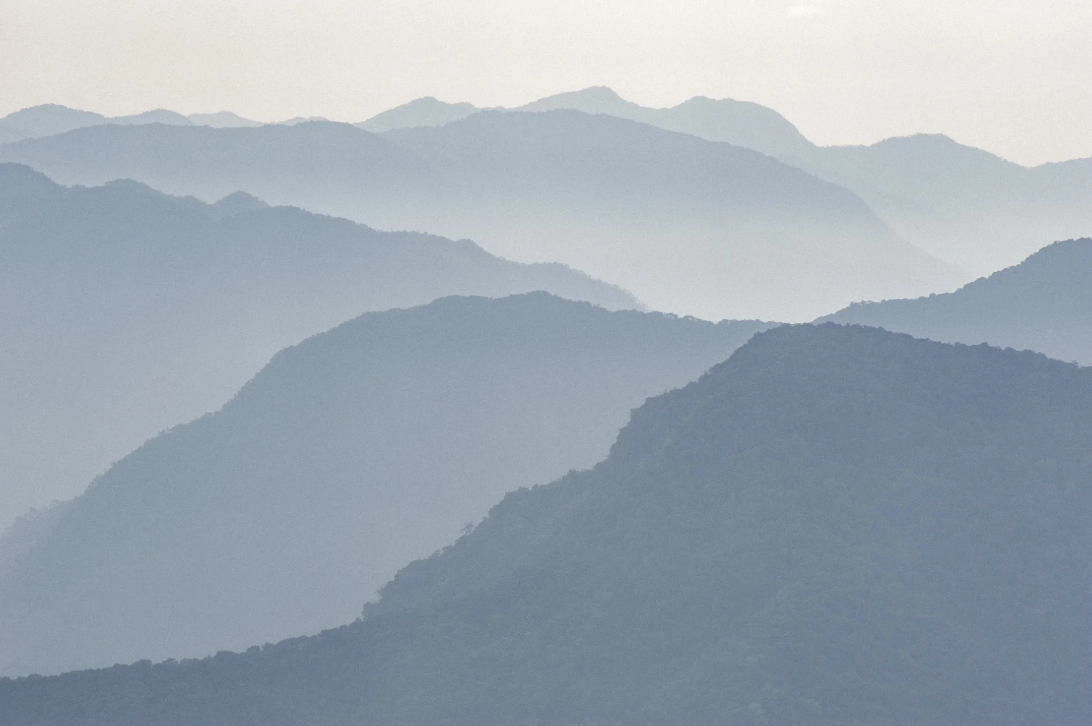 Layers of hills in east Bhutan. The image is sparse and clean. 