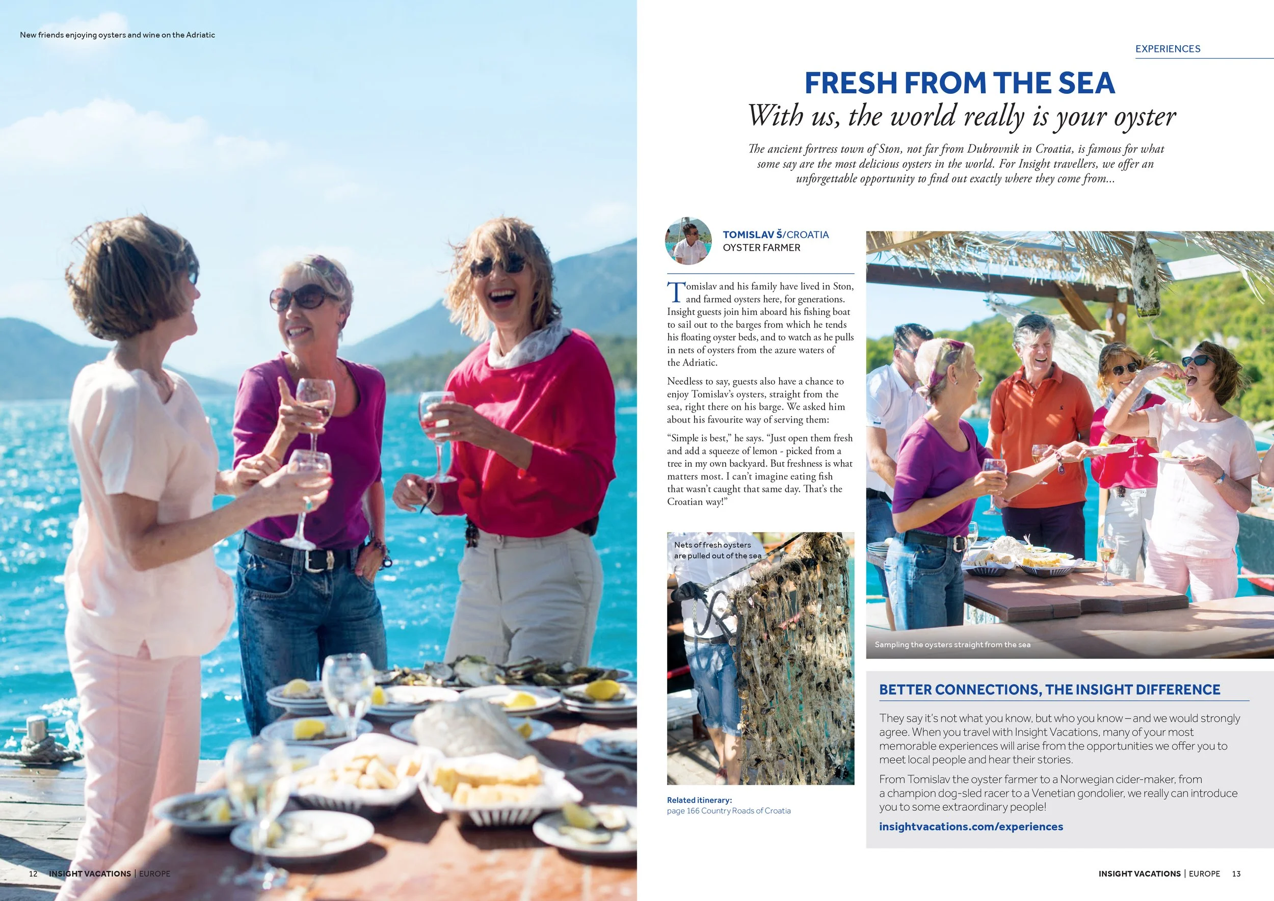 Group of women and a man enjoying a seafood picnic outdoors on a boat with the sea and mountains in the background, sharing drinks and talking.