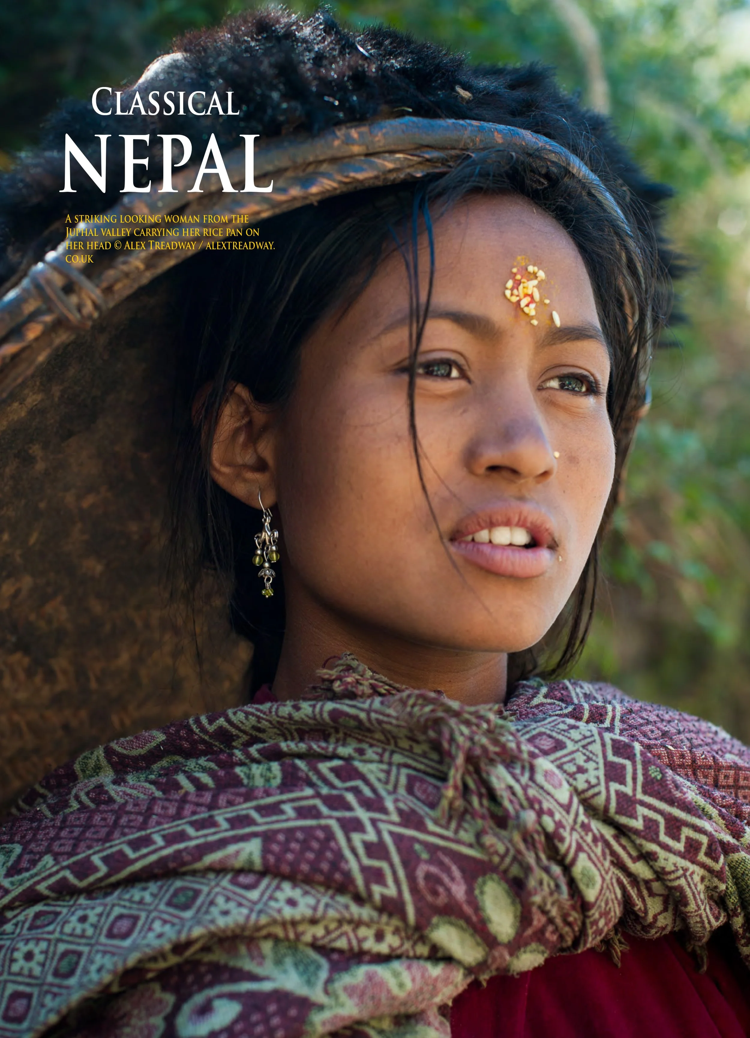 A striking woman from the Juphal Valley in Nepal, wearing a patterned shawl and earrings, looking into the distance with a serene expression, carrying a rice pan on her head.