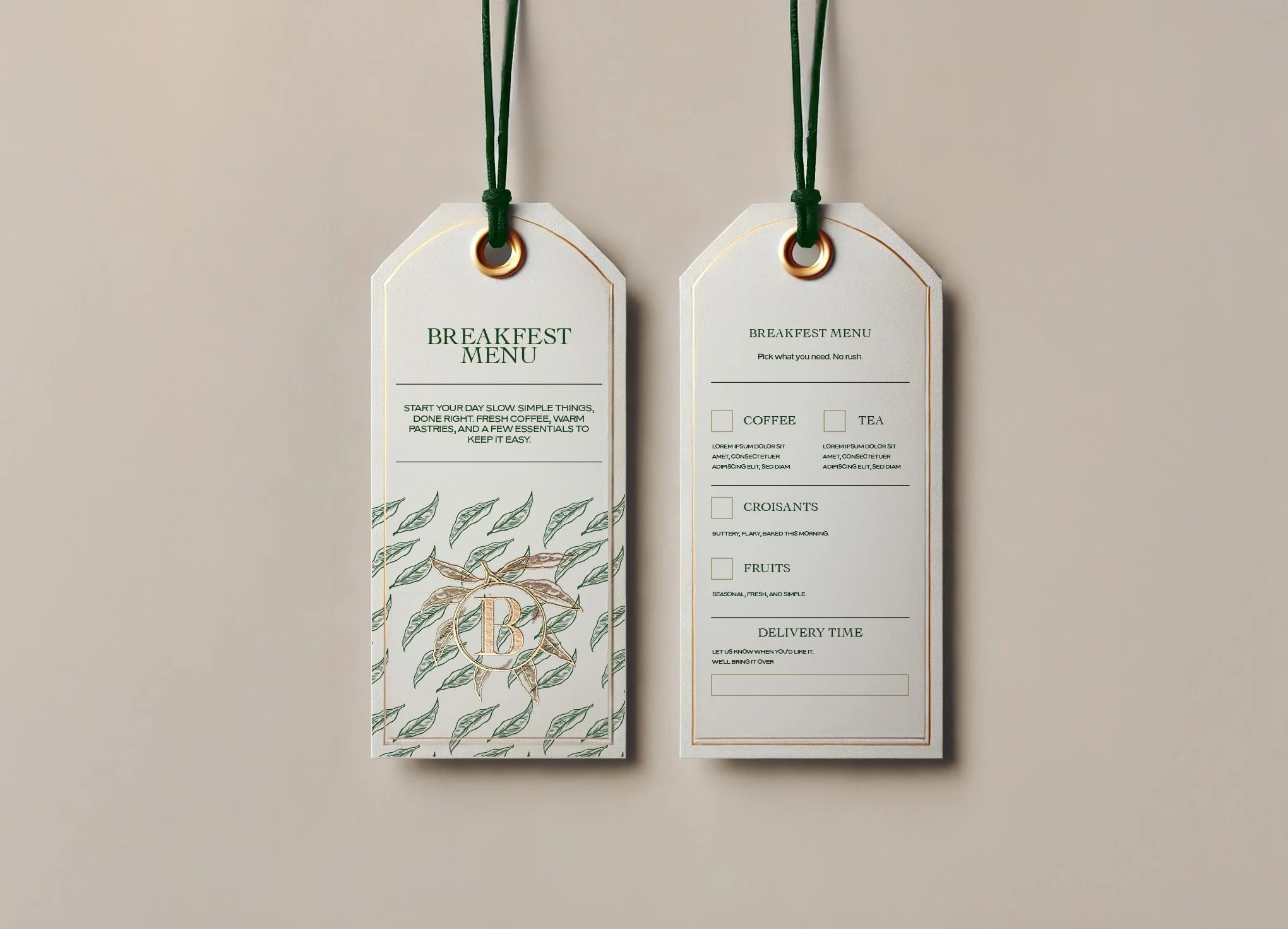 Two hanging breakfast menu tags with green strings against a beige background. The left tag features text about breakfast options and a decorative illustration of a branch with leaves, with a gold letter B in a circle. The right tag lists breakfast menu items including coffee, tea, croissants, and fruits, with sections for delivery time.