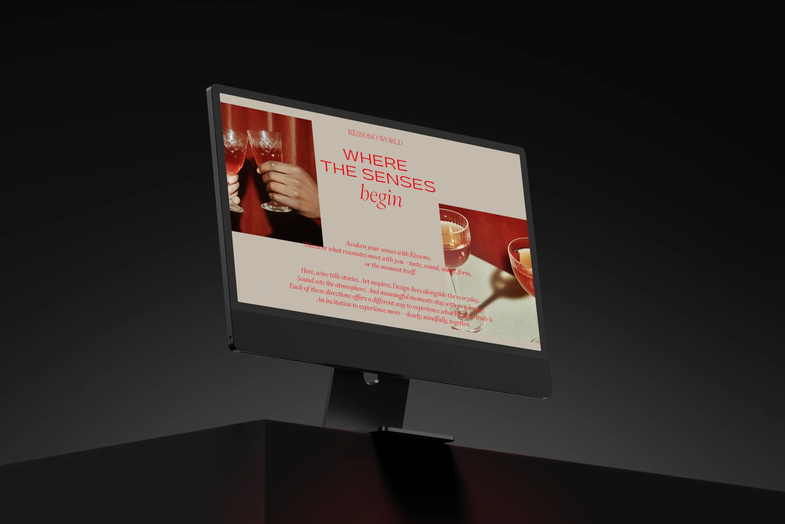 Computer monitor displaying a webpage for Réssono World with the headline 'Where the senses begin,' featuring images of wine glasses and a cocktail.