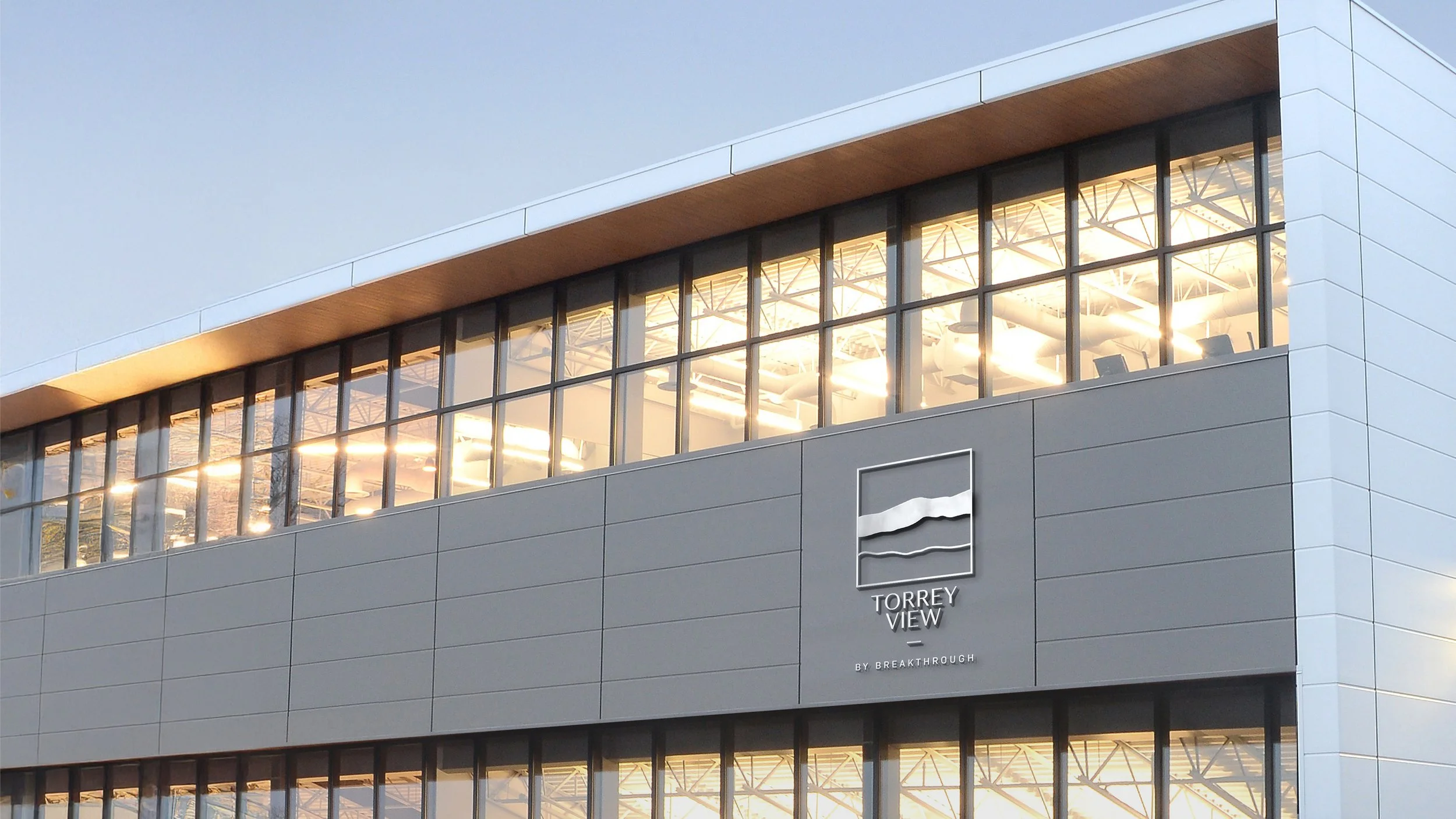 Modern building with large glass windows and a sign that reads 'Torrey View by Breakthrough.'